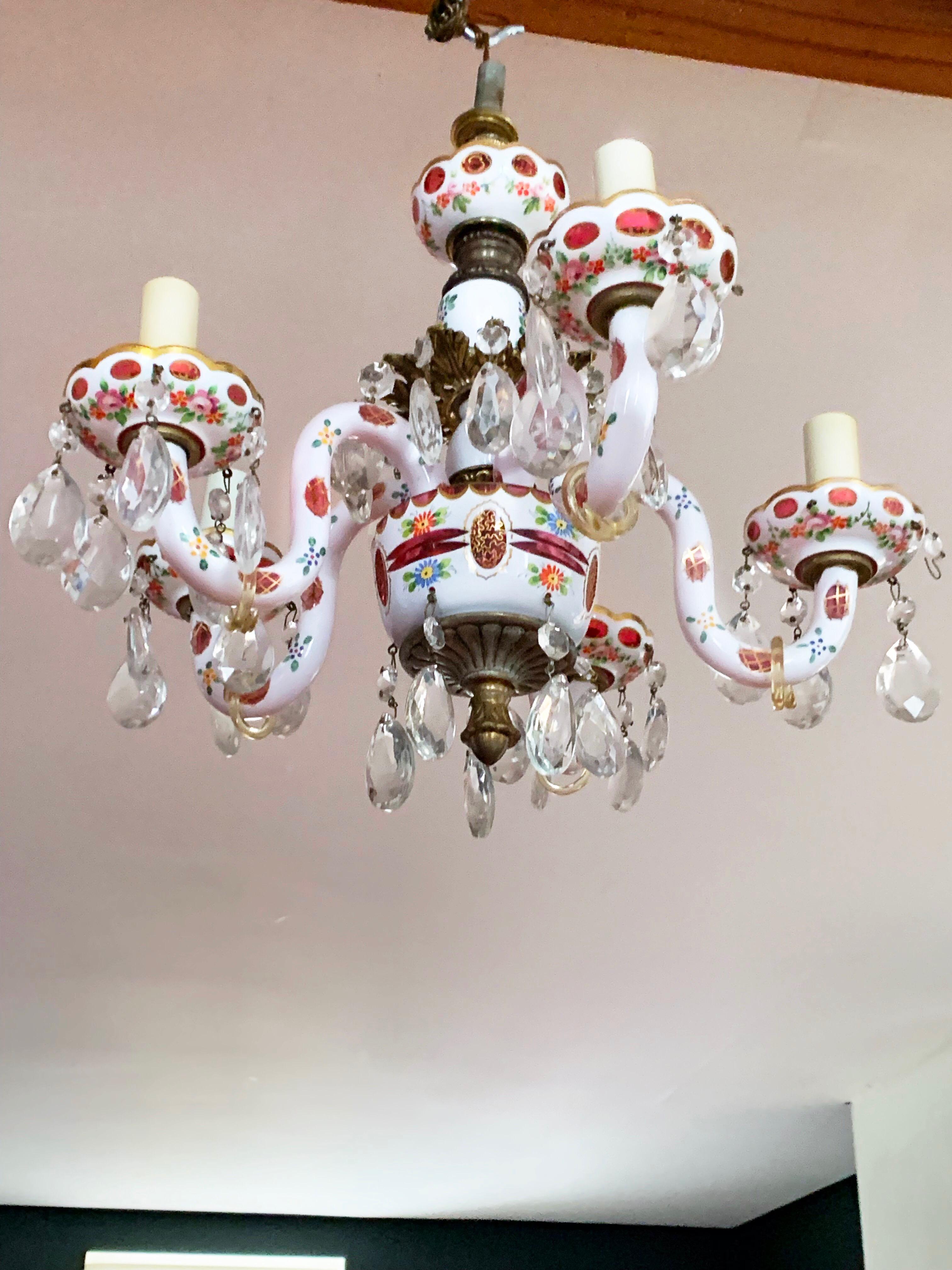 Gorgeous diminutive continental Bavarian porcelain 5-armed chandelier with cranberry glass accents and gilding. Retains original price tag from midcentury lighting dealer, 1250 USD. Somewhere in the 1960s, the crystals were swapped out with lighter,