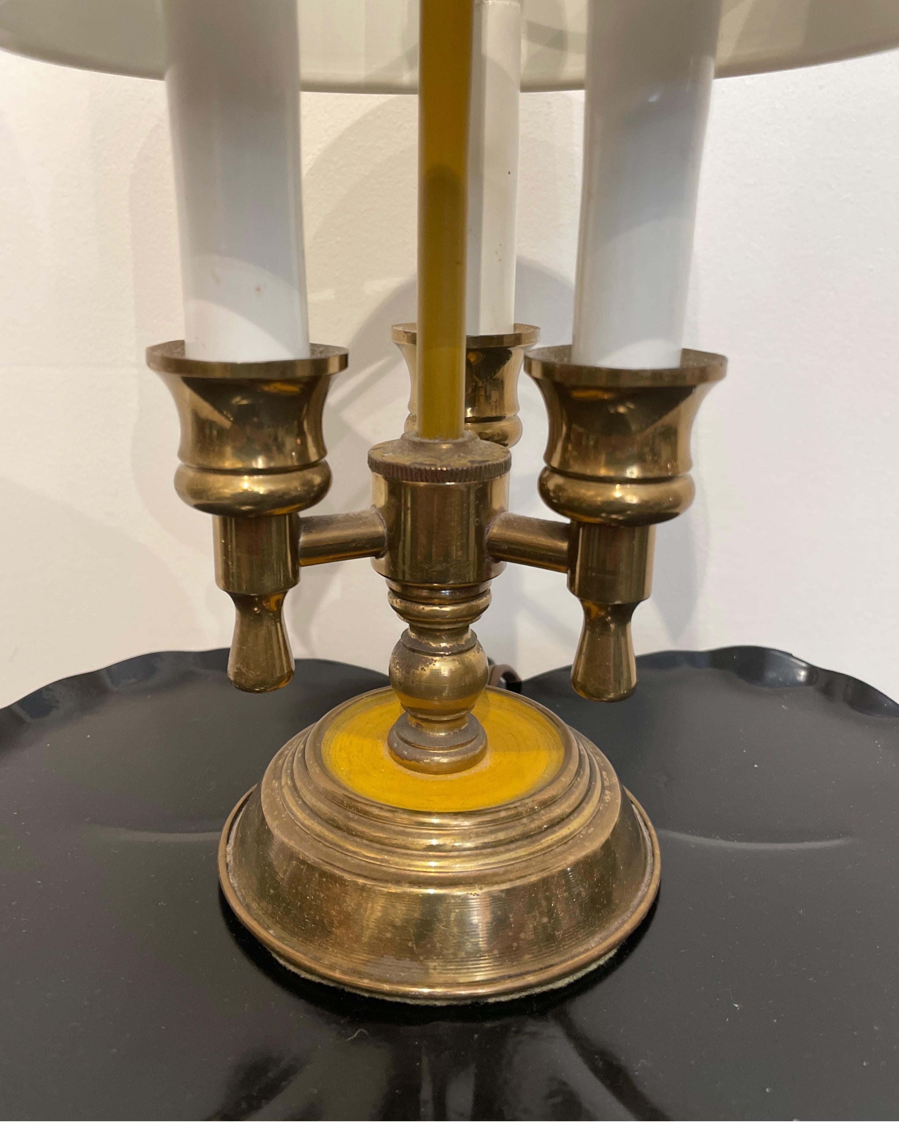Very sweet petite brass bouillotte lamp with mustard tole shade. This charming lamp will make a great accessory in any setting.