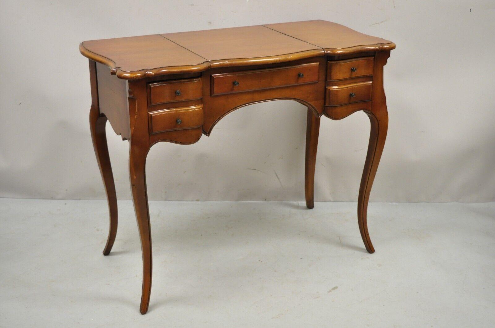 Vintage Petite French Provincial Style Cherry Flip Top Vanity table with mirror. Item features lift top with mirror, nice petite size, 2 dovetailed drawers, cabriole legs, solid brass hardware, quality American craftsmanship, great style and form.