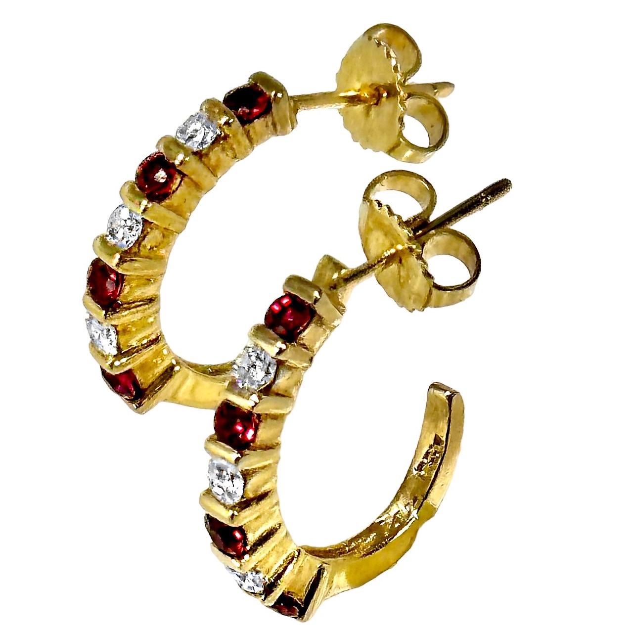 This lovely, and somewhat demure pair of 14k yellow gold hoop earrings are set with eight vibrant, rich red rubies and with six brilliant cut diamonds. Total approximate ruby weight is .45ct and total approximate diamond weight is .40ct. Overall