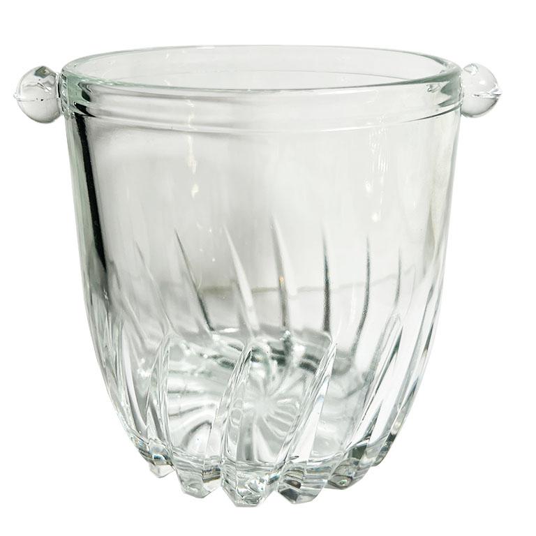 A petite glass ice or champagne bucket with handles. This piece is a necessity for any bar. Fill it with ice for guests to create their own cocktails. Or use it as a wine or champagne chiller. We also like the idea of using it as a vase and holding