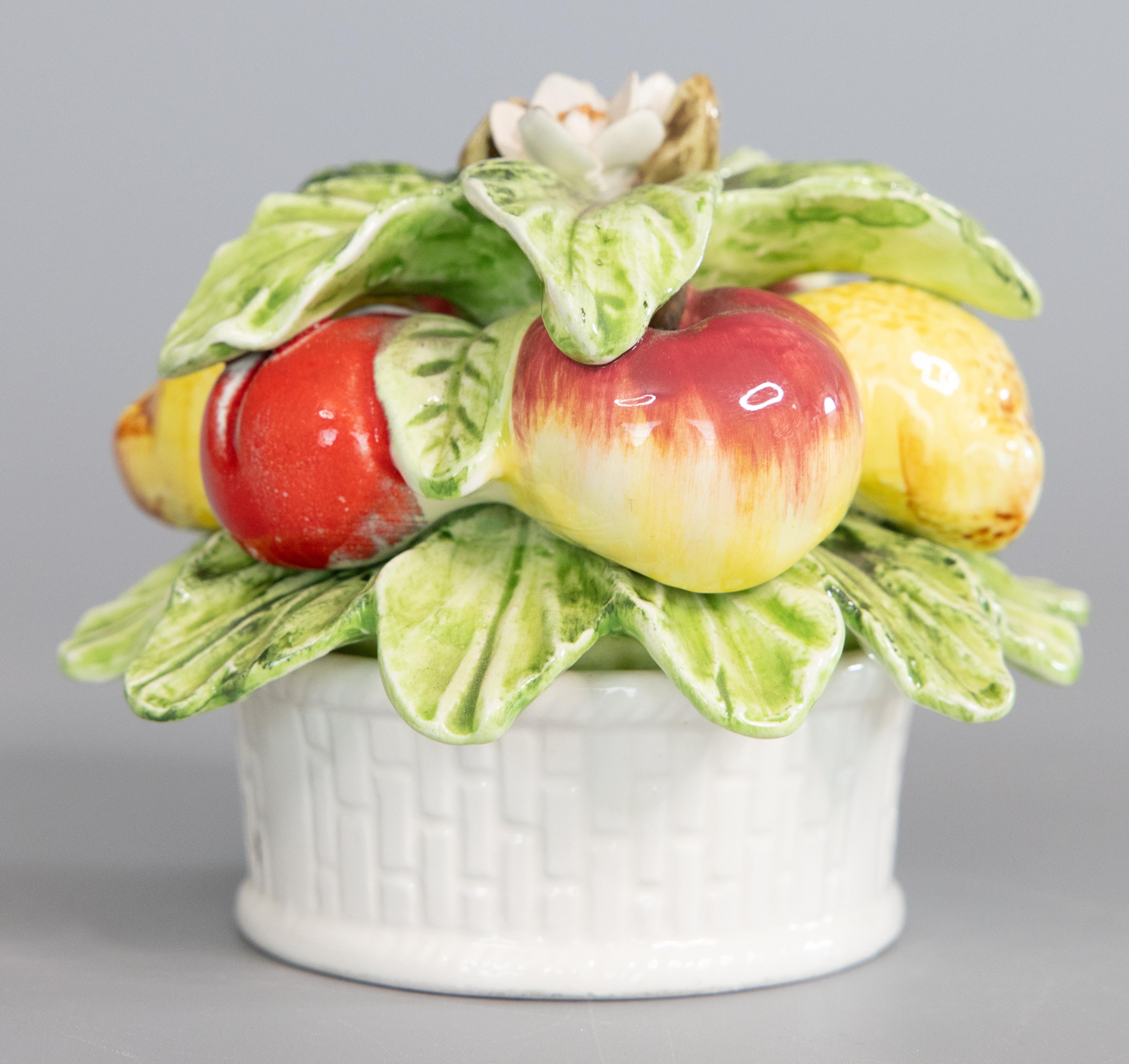 A lovely miniature Mid-Century Italian majolica basket of lemons, apples, and peaches accented by green leaves and flowers in a white basket. Maker's mark on reverse. Freshen up your kitchen or breakfast room with this charming