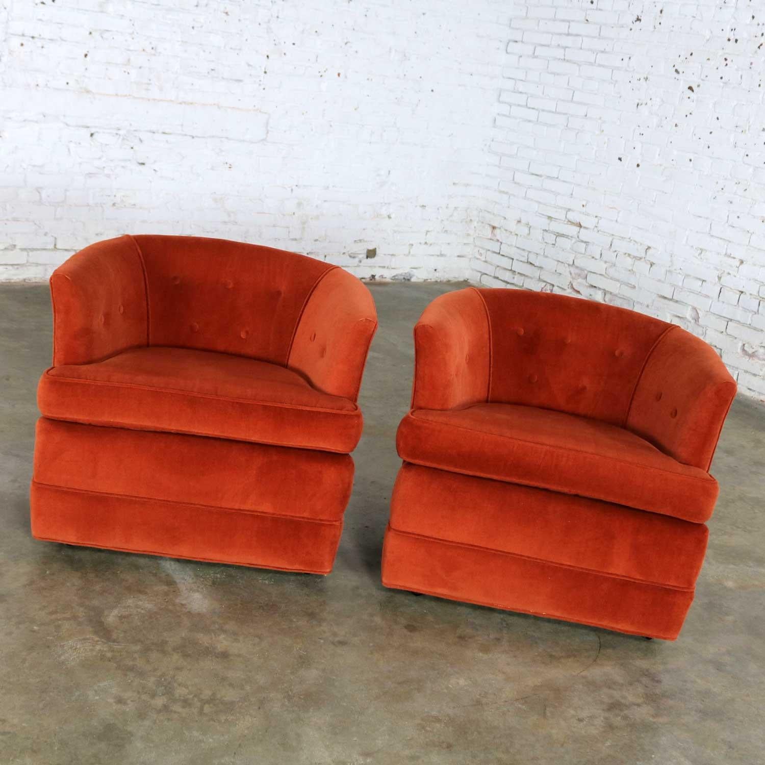 Handsome pair of petite Hollywood Regency or MCM style barrel chairs in a burnt orange velvet and on casters for ease of placement. They are in fabulous vintage condition. Their original fabric looks almost brand new. Please see photos, circa