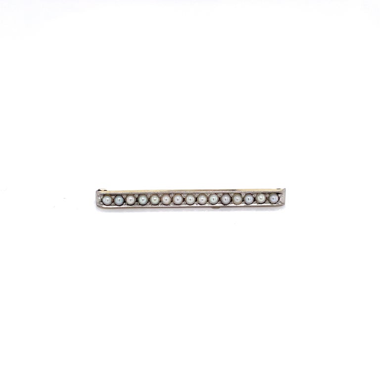 Enjoy this charming little vintage treat decorated with petite pearls in platinum. The bar pin is made of 10 karat yellow gold and measures 1-5/8 inch in length. 
Fitted with a simple C Clasp. Gift boxed.