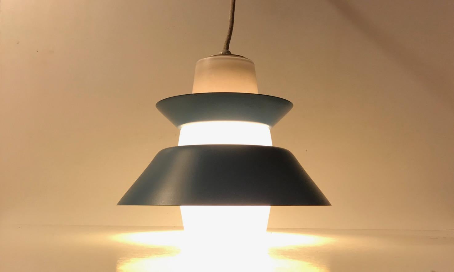 Ceiling light from Voss Belysning in Denmark. Manufactured during the 1950s in a style reminiscent of Stilnovo and Svend Aage Holm-Sørensen. It is composed of a cased opaline glass shade and has two over-laying petrol blue steel shades/diffusers.