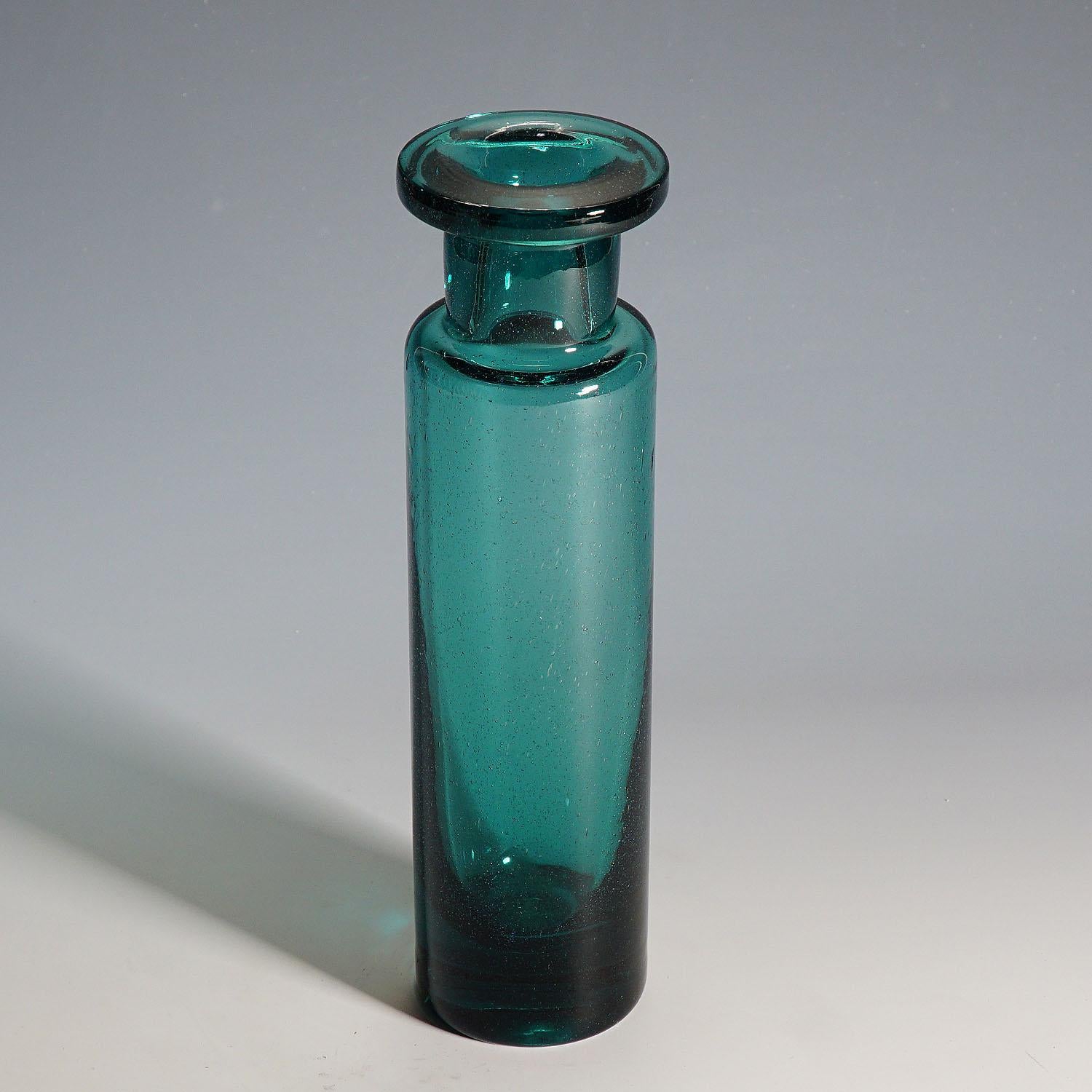 A vintage glass vase manufactured in massive petrol colored glass with fine air bubbles inside. Manufactured by the Ichendorfer Glassworks, Germany around 1960. The Ichendorfer Glassworks issued a series of replicas of antique Roman Aryballos glases