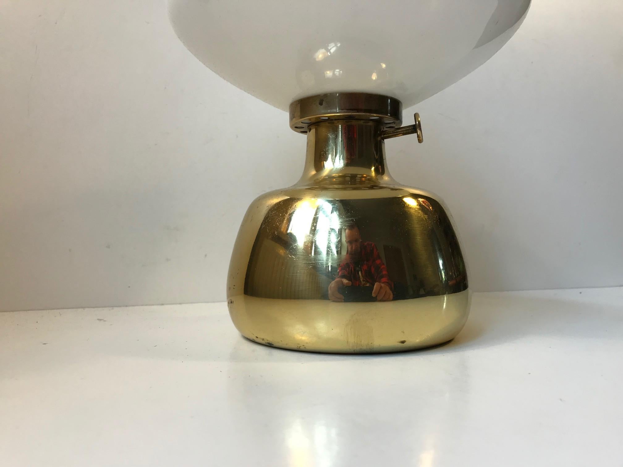 - Designed by Henning Koppel (1918-81) in the 1960s
- Manufactured by Louis Poulsen in Denmark
- The Petronella oil lamp is made from brass with an opaline glass shade.