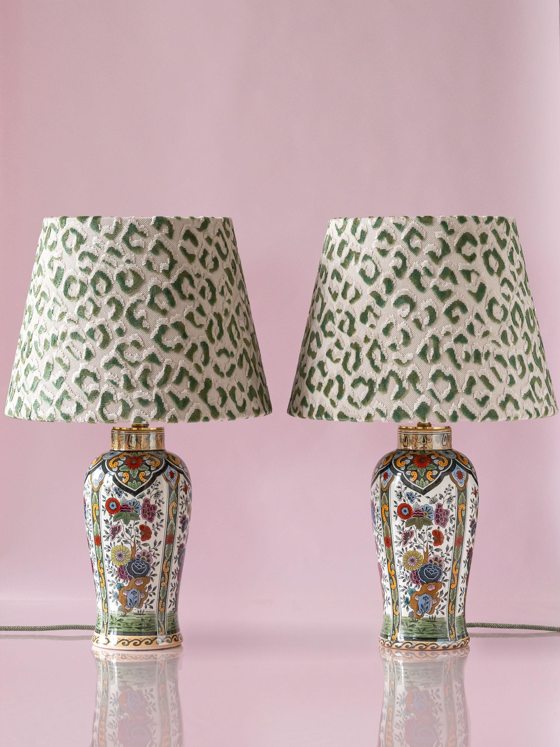 These one-of-a-kind lamps have been lovingly handcrafted from two vintage vases in a Delft Polychrome style made by De Sphinx (formerly Petrus Regout) in Maastricht, the Netherlands. The shades were handmade by an atelier in Amsterdam in a funky
