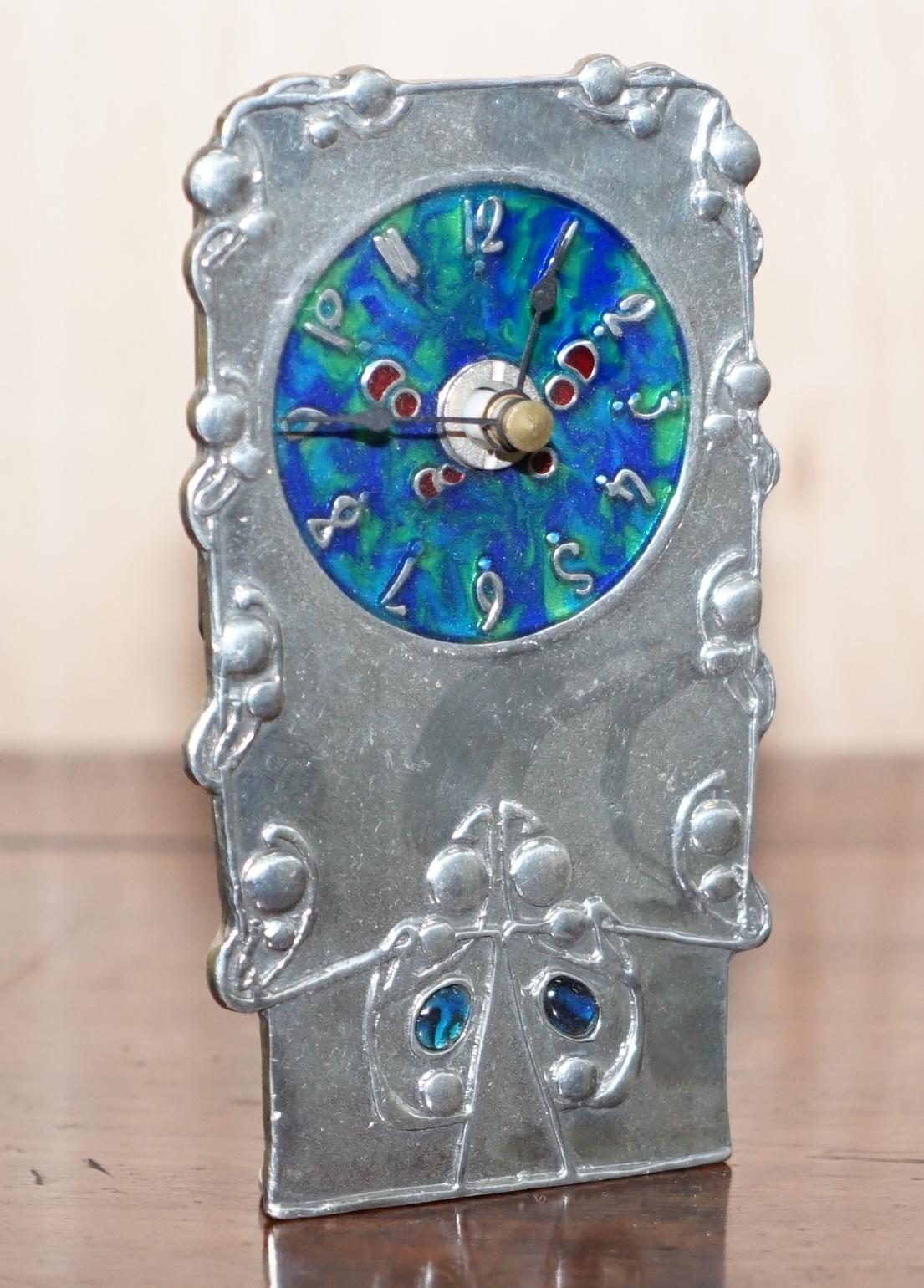 We are delighted to offer for sale this lovely 1903 Liberty London Archibald Knox Tudric Pewter enamel carriage clock

This clock is an excellent example of the very collectable carriage clocks designed by Knox for Liberty, it has the gorgeous