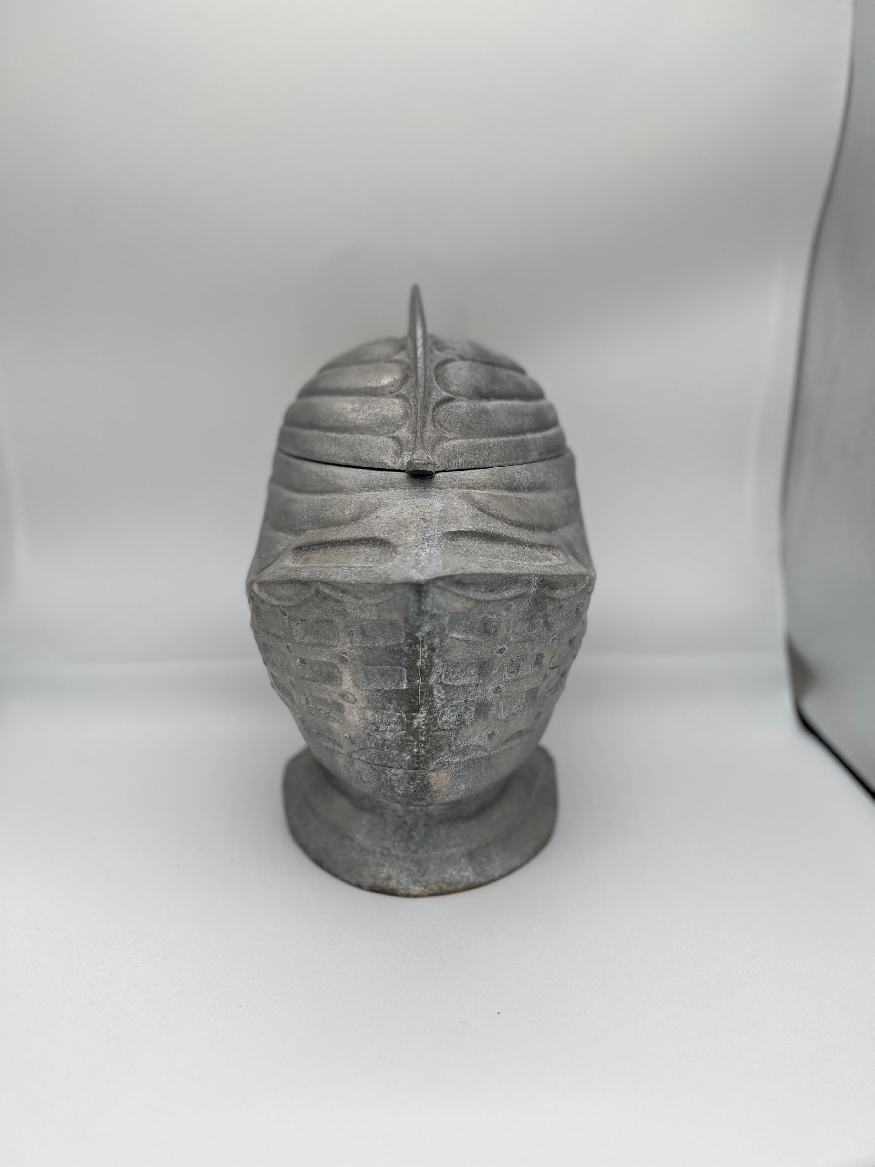 A mid century vintage pewter and mixed metal ice bucket in the form of a Renaissance knight’s helmet. 