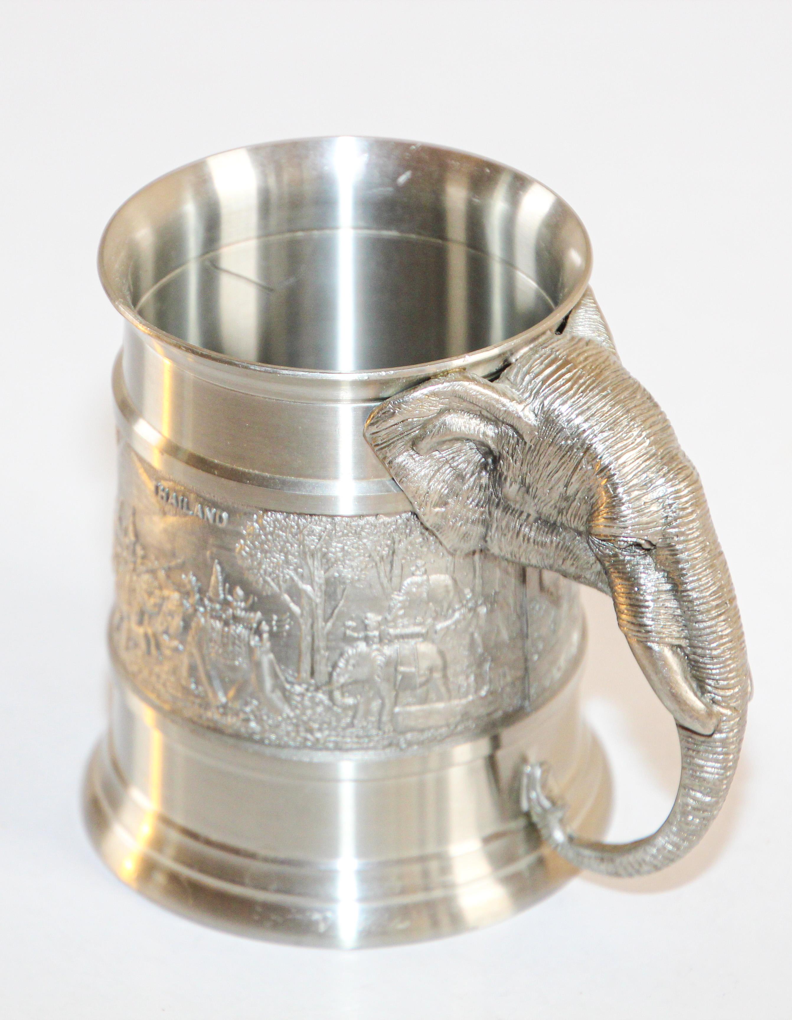 Elephant pewter mug with highly detailed embossed with motifs of elephants which is thee symbol of Thailand
Vintage Oriental pewter mug cast carved embossed design with elephant handle head.
The elephant is Thailand’s National Symbol. 
Handmade