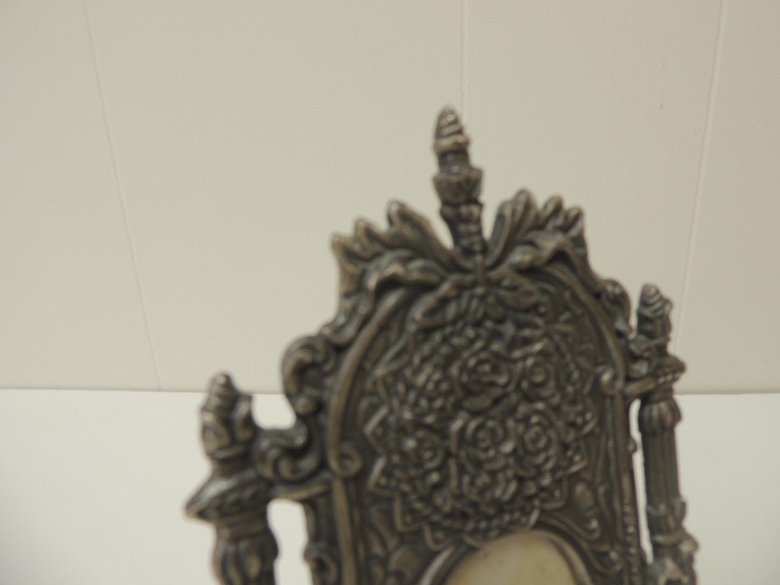 Vintage pewter picture frame in shape of a cheval floor mirror.
Velvet backing. The frame depicts, flowers, tassels, columns and bows.
Inside image ot picture size: 2 x 3
Size: 5 x 8 3/4 x 1/4 inch thick.