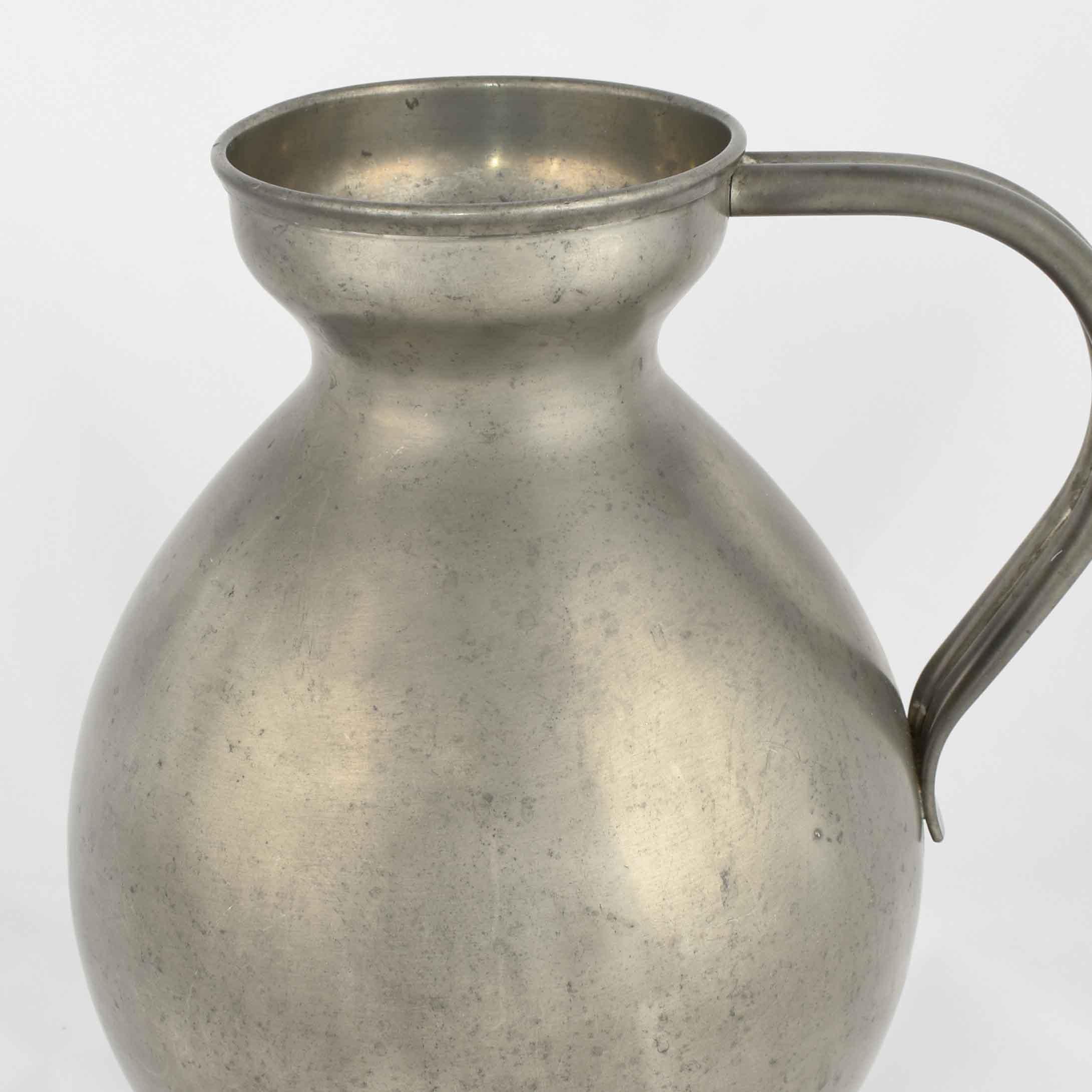Die Vase mit Henkel ist ein originelles Dekorationsobjekt, das in den 1930er Jahren in Deutschland hergestellt wurde. 

Original Metallarbeiten.

Erstellt von Harald Buchrucker. 

Guter Zustand: kleine Anzeichen von Alterung.

Schönes