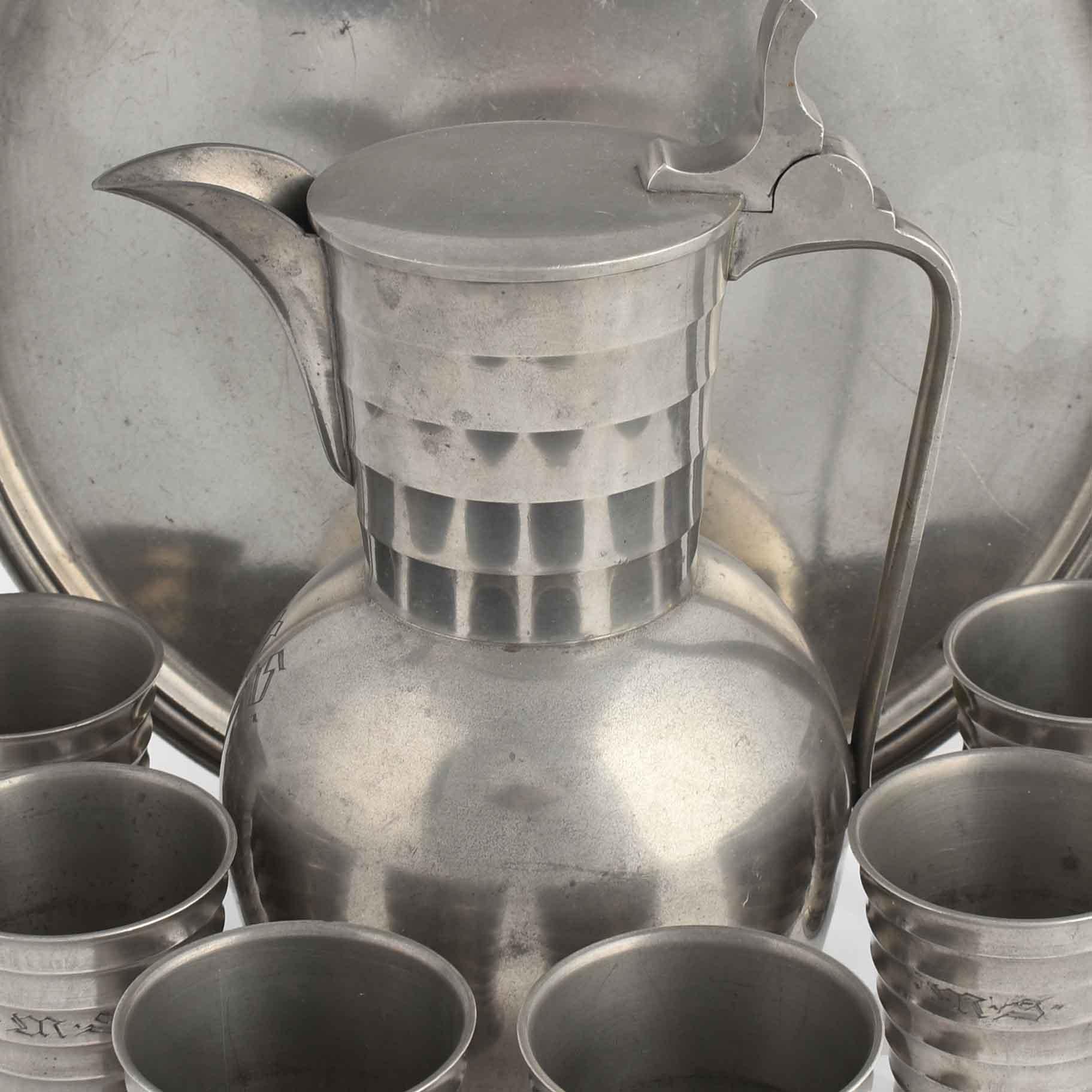 Vintage Pewter wine set is an original group of decorative objects realized in 1938 and made in Germany. 

Original pewter by Eugen Wiedamann Foundry. 

Created by Wolfgang von Wersin. 

The set includes: a tray (dimensions: 35 cm), six mugs