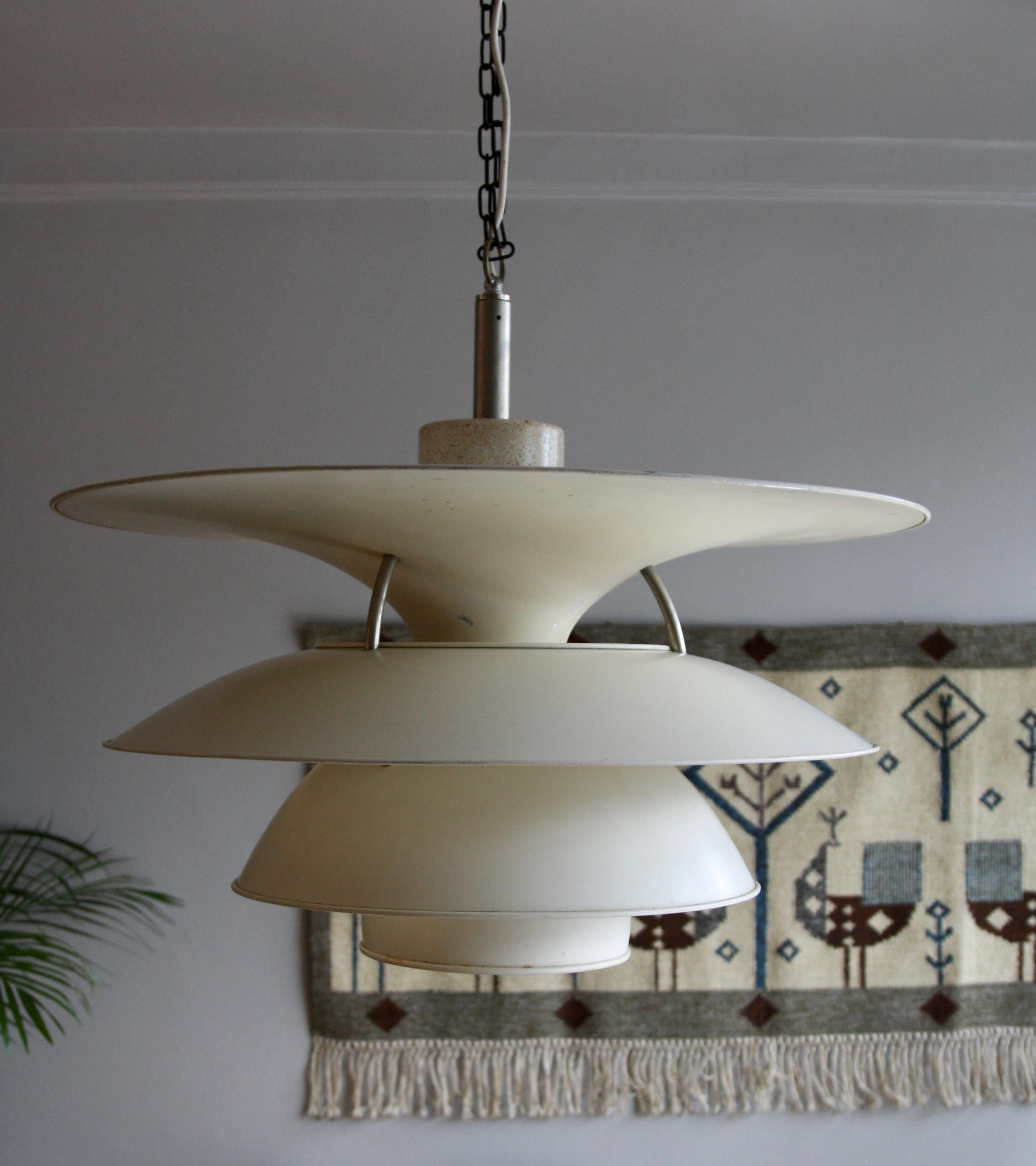 An enormous vintage PH chandelier designed in 1979 and made in the Early-1980s. 
Henningsen's original four-shade light was launched in 1931. This piece is an example of the redesigned four-shade light achieved by two Danish architects – Sophus