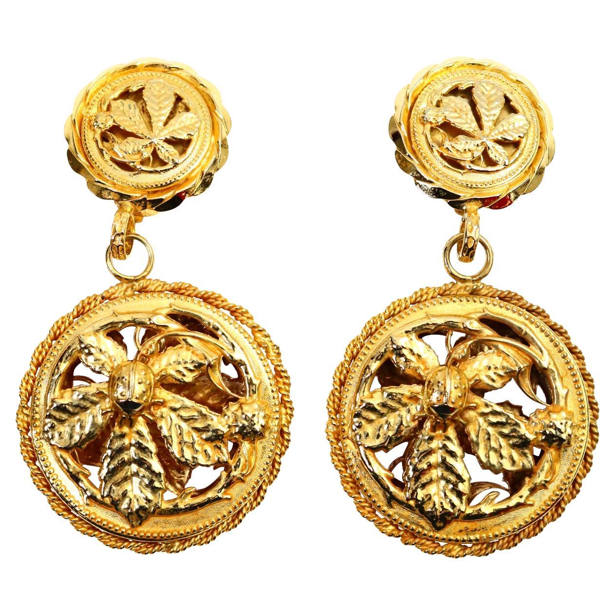 Vintage Philipe Farrandis Dangling Gold Tone Earrings Circa 1980s.  These are so chic. Looks like a plant with a small ladybug on the plant though not really easy to detect. A spectacular piece. Front Facing and Bold with Quite a look. Clip On.

THE
