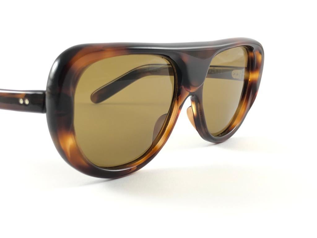 A True Iconic Philippe Chevallier Robust Frame Sporting A Beautiful Pair Of Medium Brown Lenses. 
This Pair May Show Slight Wear On Them Due To To Nearly 50 Years Of Storage  Please Study The Pictures Before Buying.


This Pair Of Vintage Philippe