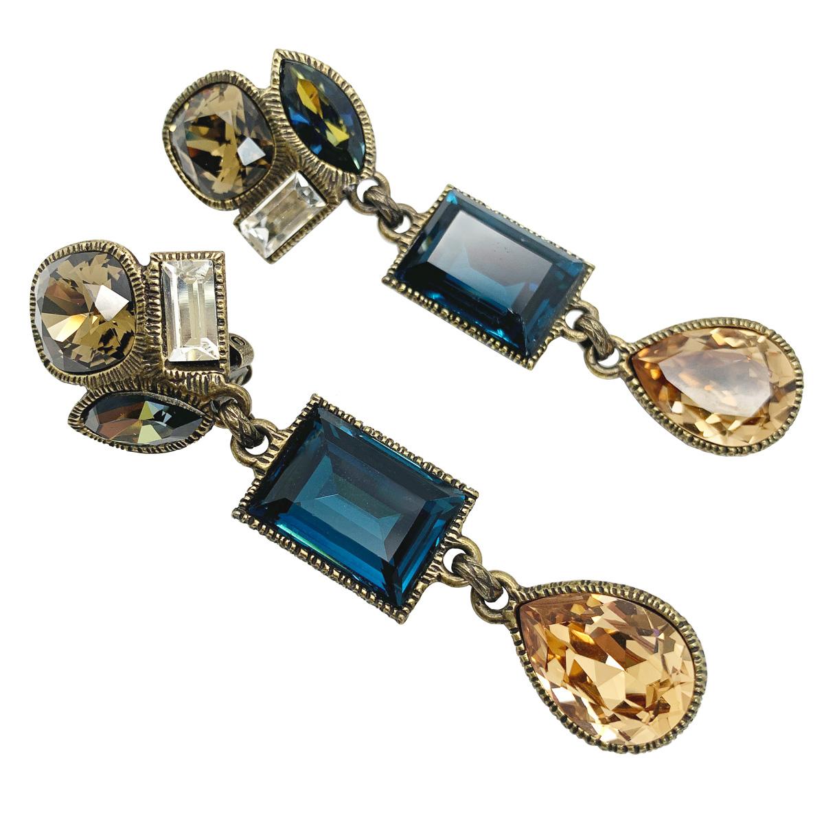 A divine pair of Vintage Philippe Ferrandis Earrings. Featuring a myriad of fancy cut crystals in earthy tones including citrine alongside deepest sapphire blue.

Vintage Condition: Very good without damage or noteworthy wear.
Materials: bronzed