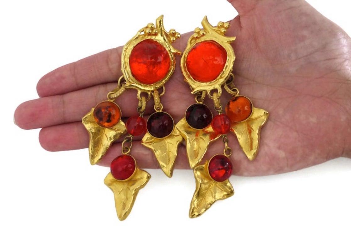 Vintage PHILIPPE FERRANDIS Poured Glass Grape Leaves Earrings

Measurements:
Height: 4 1/8 inches
Width: 2 inches

Features:
- 100% Authentic PHILIPPE FERRANDIS.
- Grape fruit with vine leaves charms.
- Raised dome gripoix/ poured glass in ruby and