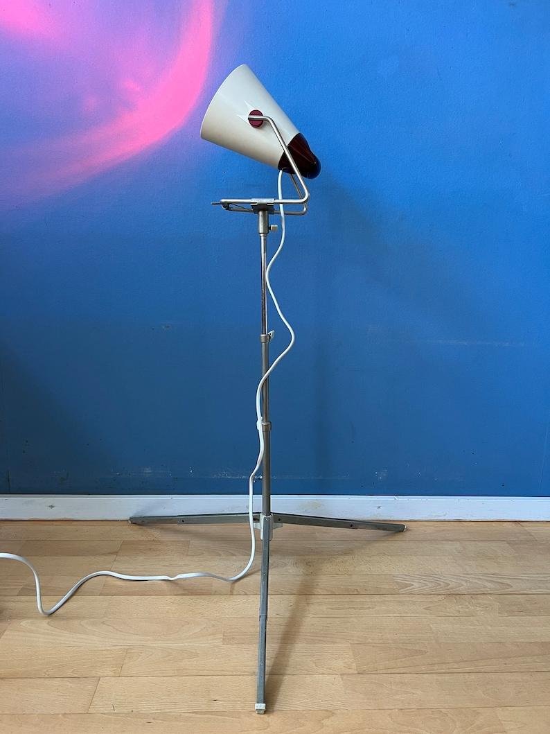 Vintage Philips Infraphil heat floor lamp. This lamp emits infrared radiation, which is a form of electromagnetic radiation that produces heat when absorbed by the skin or objects. It's commonly used for therapeutic and heating purposes. The lamp