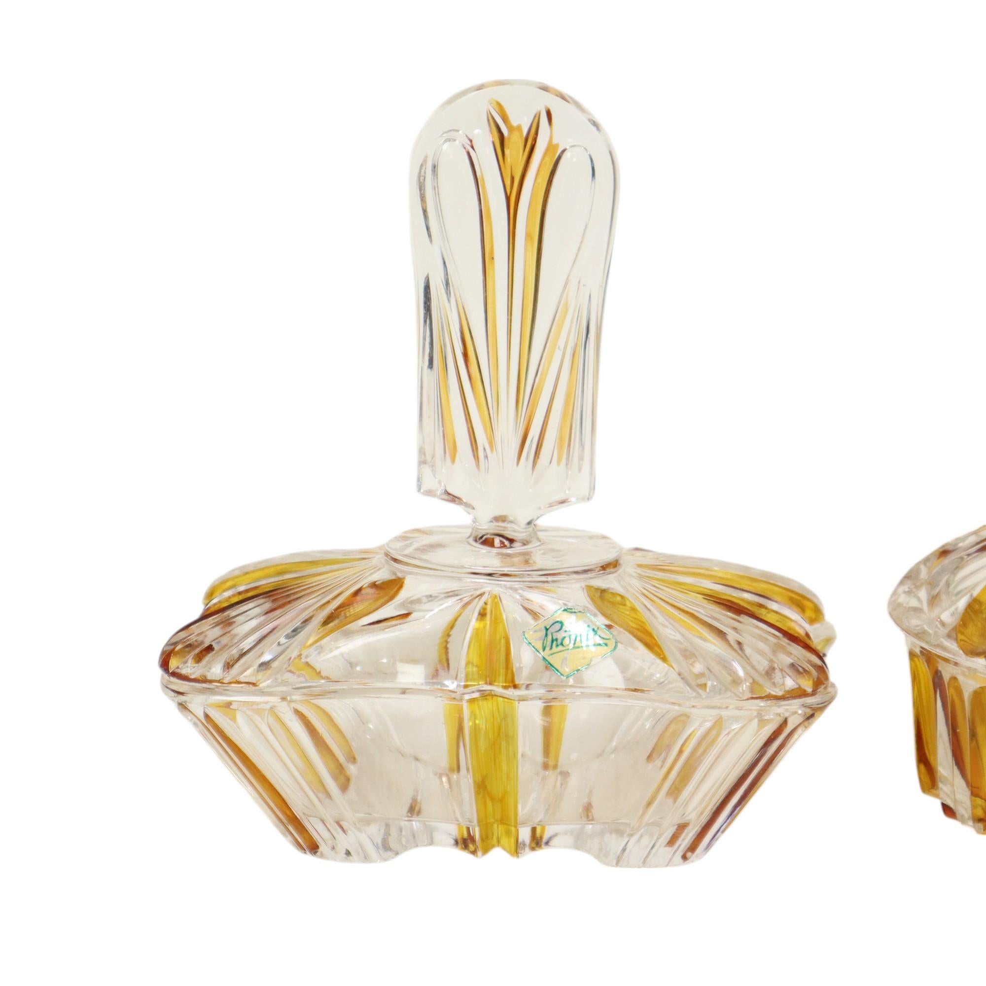 Vintage amber and transparent toiletry set, boudoir or perfume set, completely in art deco style, made of blei crystal or lead crystal, marked Phönix, circa 1950s.

Nice and colorful set, very nice on a dressing table, this set consists of 2 storage