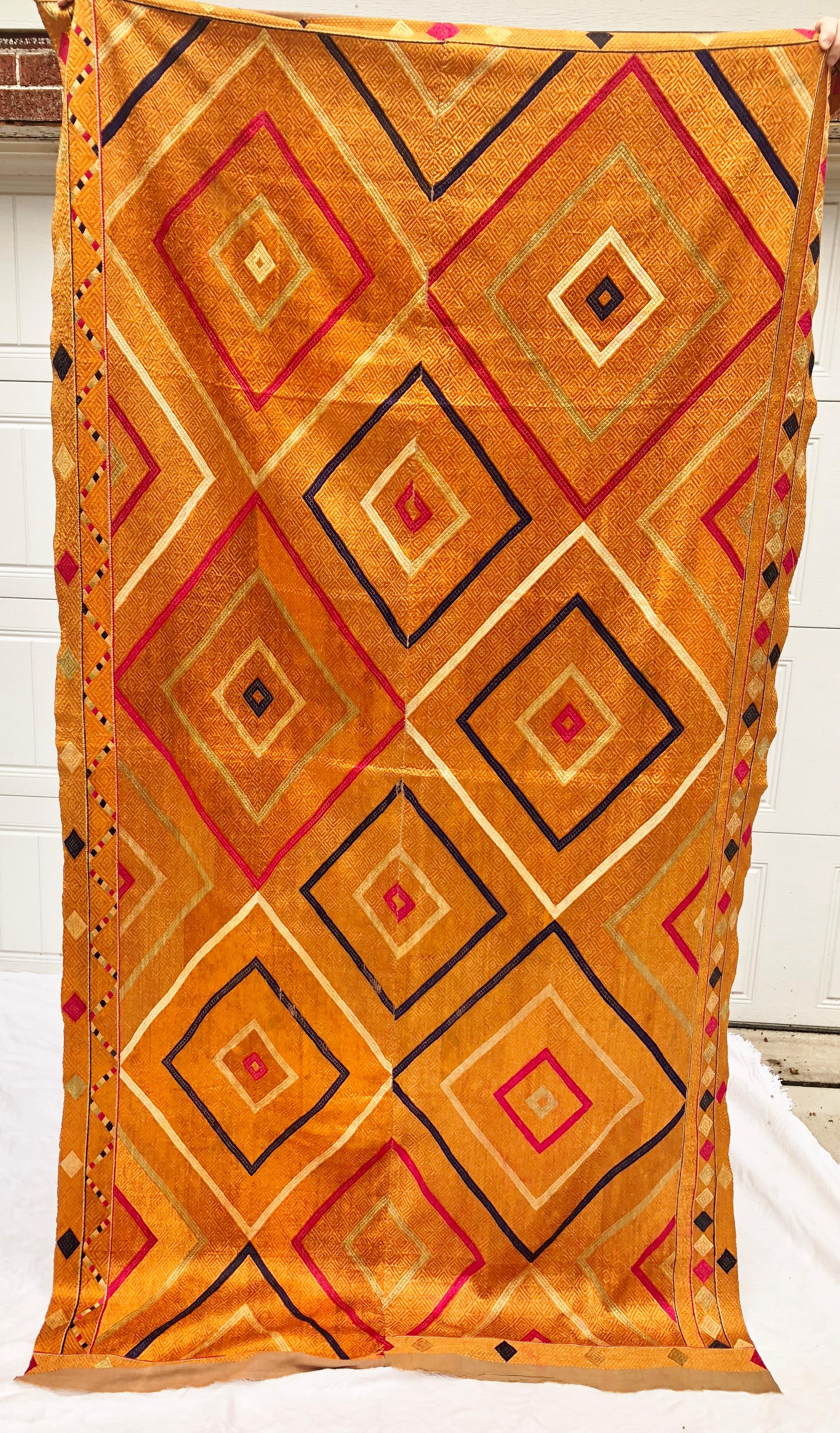Vintage phulkari bagh wedding shawl from Punjab, India. The cotton hand loomed khadi cloth is hand embroidered with vibrant silk threads by members of the young girl's family for her wedding. Shawl is in very good condition for it's age. This is a