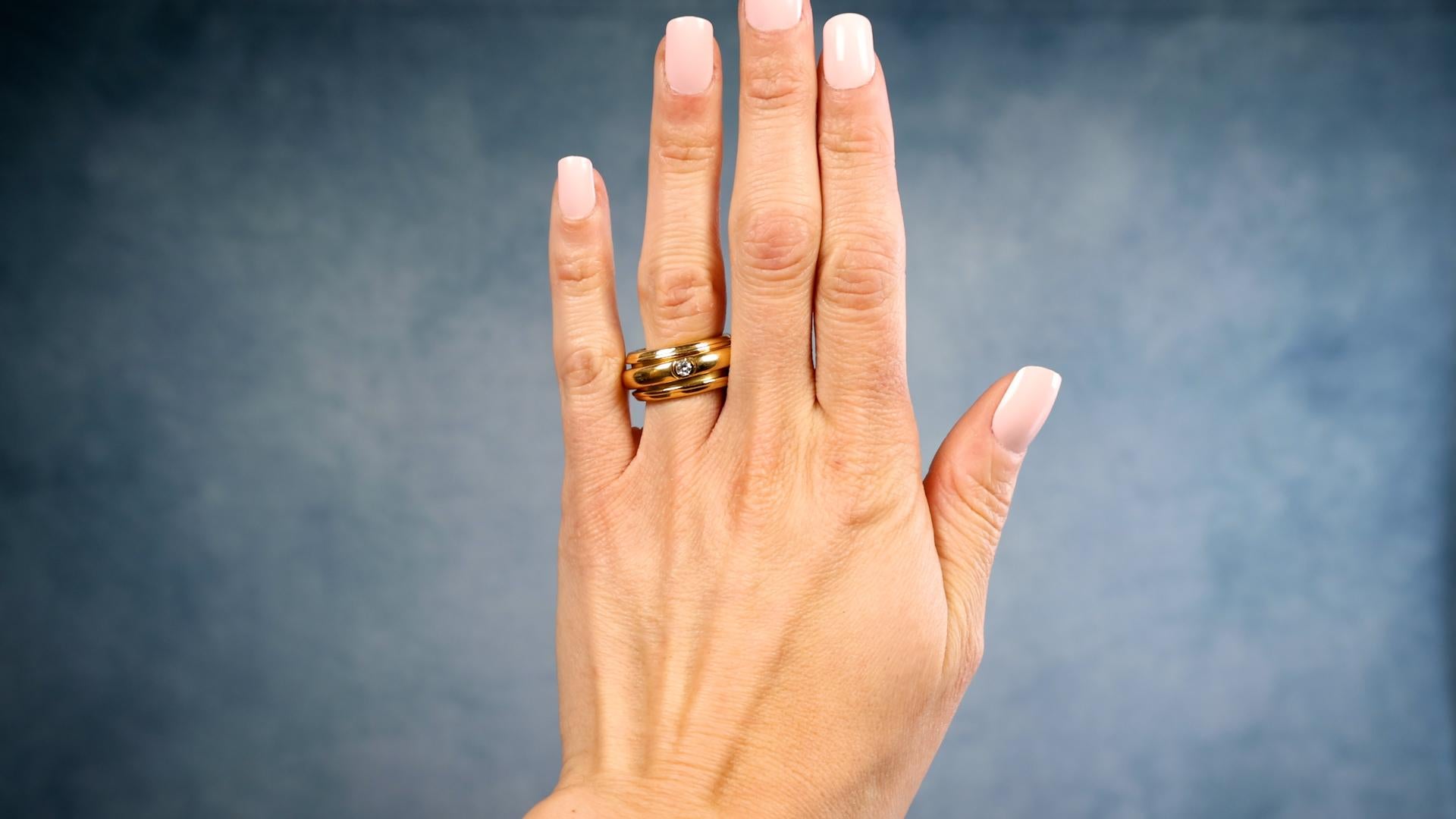 Une bague Vintage Piaget 0.13 Carat Diamond 18k Yellow Gold Possession Spinner Ring. Comprend un diamant rond de taille brillant de 0,13 carat, de couleur E et de pureté VVS2. Réalisée en or jaune 18 carats, signée Piaget, numéro de série A35247,
