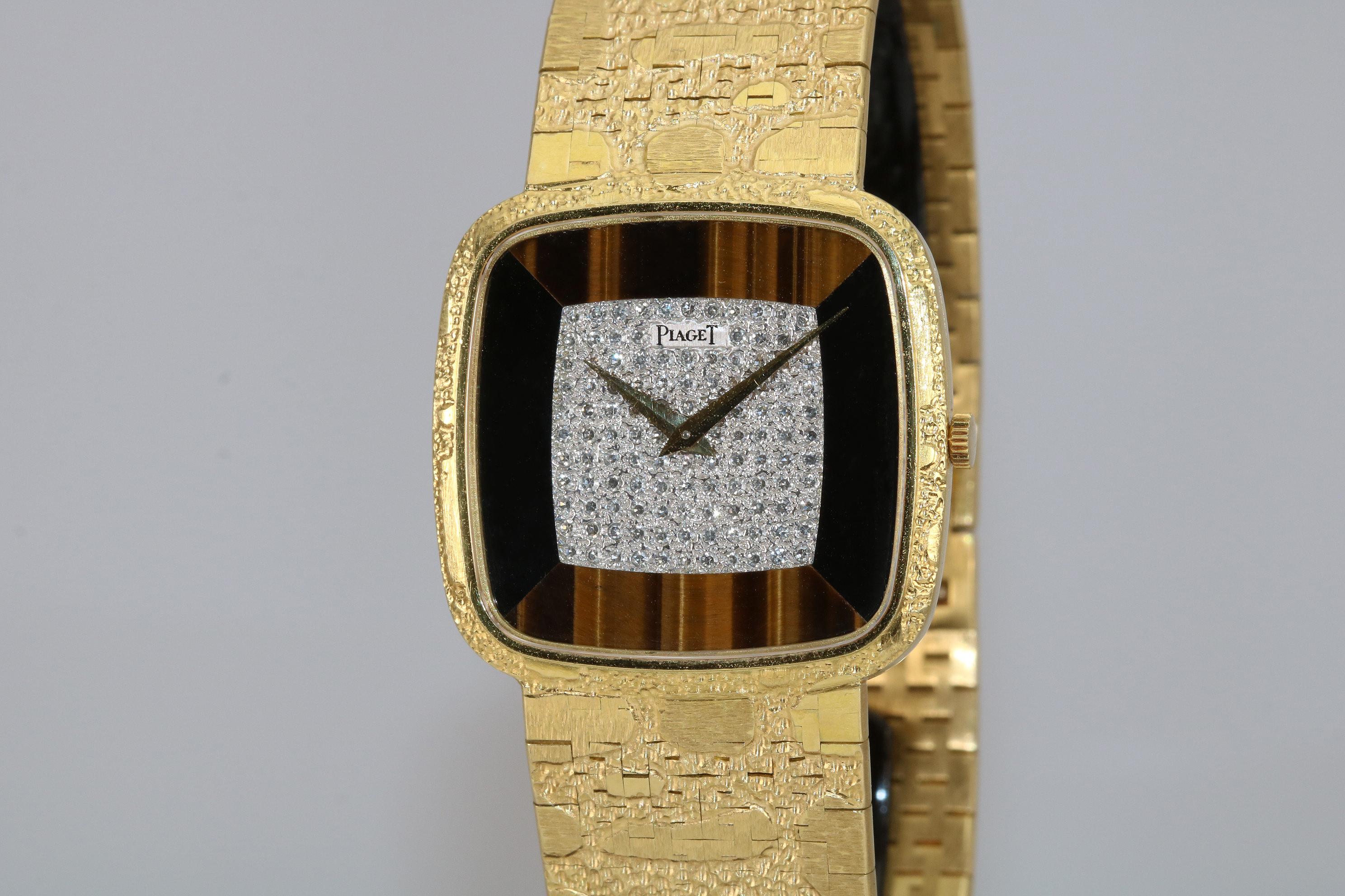 Piaget diamond, tiger's eye and onyx 18k yellow gold wristwatch with an 18k yellow gold integrated textured Piaget bracelet and folding clasp.