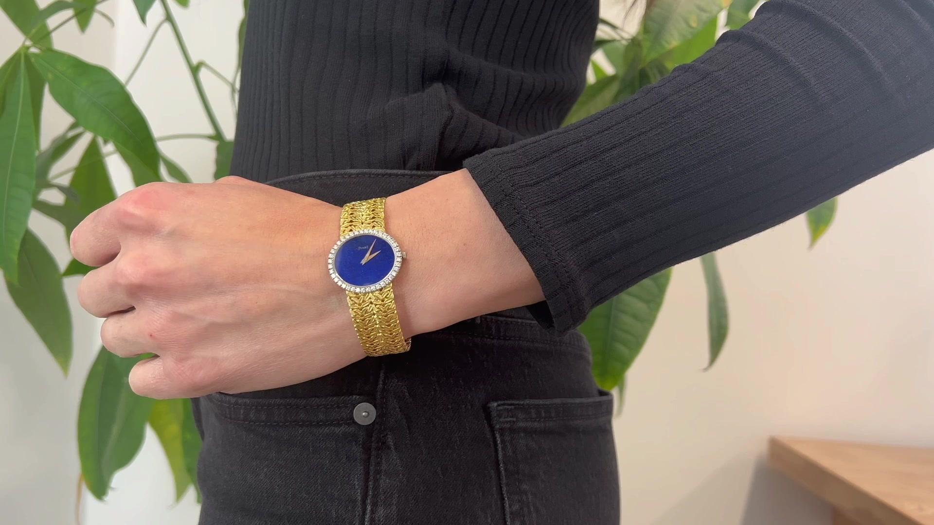 One Vintage Piaget Lapis Diamond 18 Karat Yellow Gold Wristwatch. Featuring 40 round brilliant diamonds with a total weight of approximately 1.00 carat, graded D-E color,  VVS clarity. Lapis face. Crafted in 18 karat yellow gold with watch face in