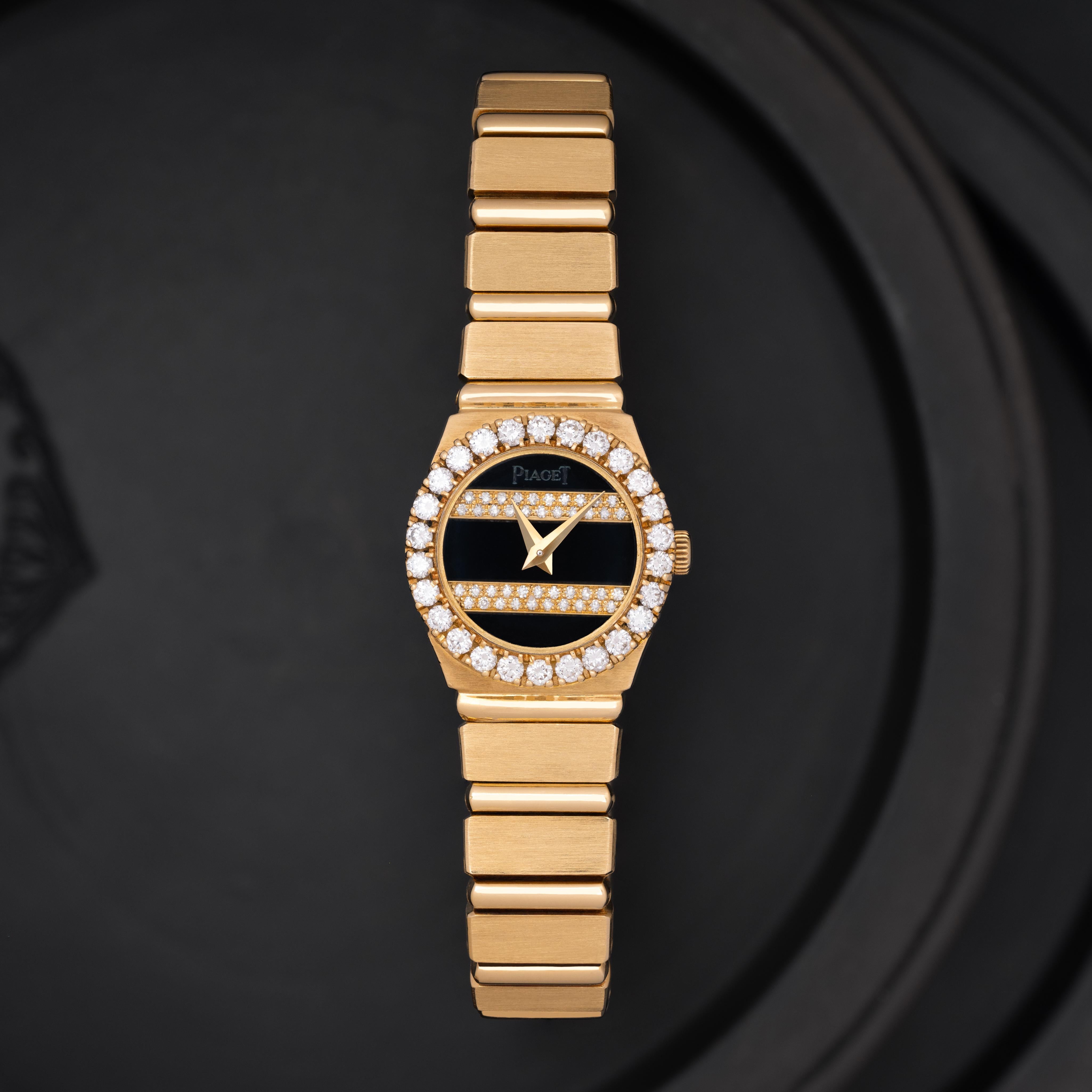 Maker: Piaget
Model: Polo 846C701
Year: c. 1980s
Material: 18K Yellow Gold and Diamonds
Dial: Onyx with Diamond Bands and Diamond Bezel
Case Measurement: H 20mm x 19.5mm
Movement: Quartz
Condition: Very good.
Weight: 69 Grams
Size: Adjustable, Fits