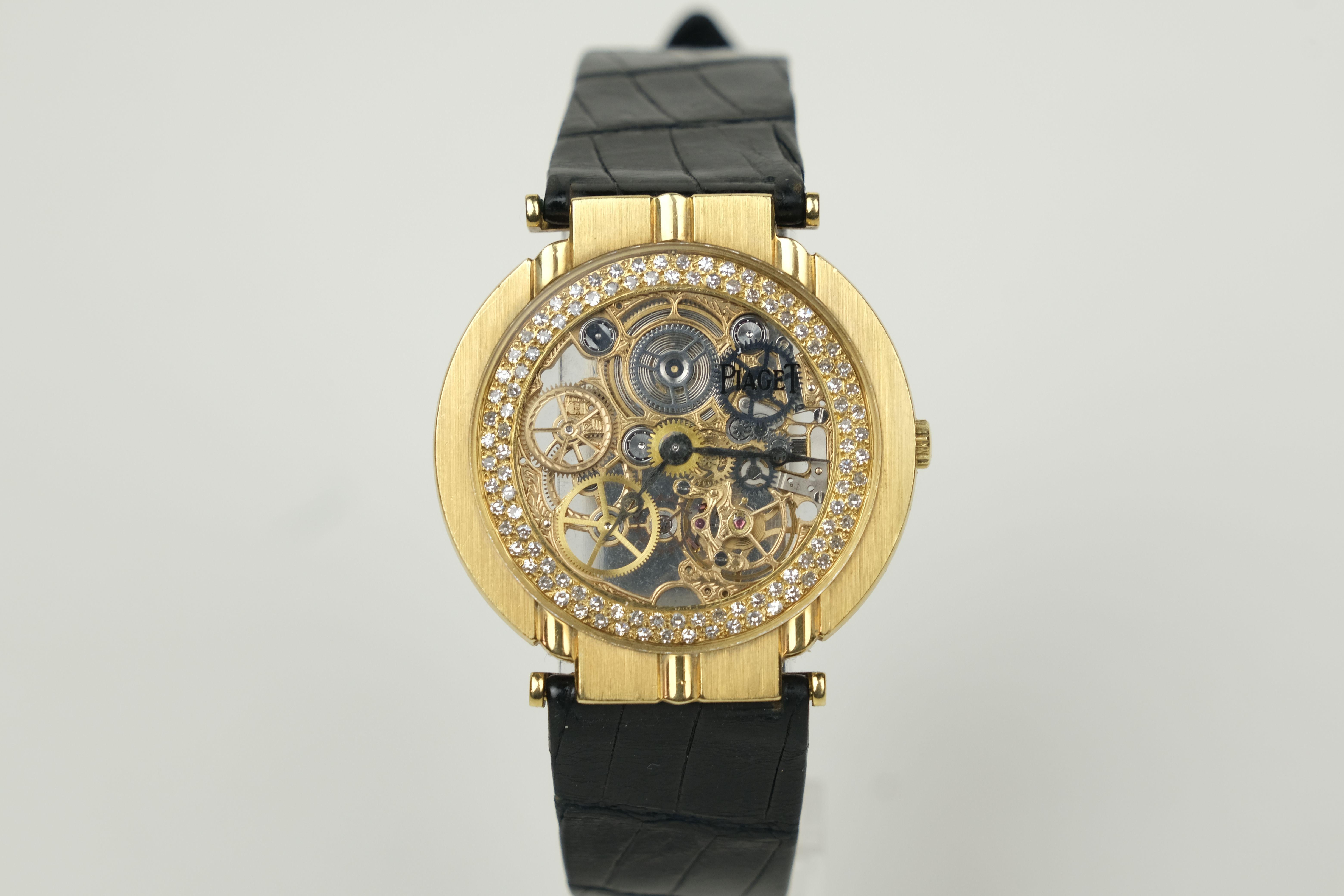 An 18K Gold and Diamond Vintage Piaget Polo Skeleton Stem Wind Wristwatch.

 Ultra-thin skeletonized movement with engraved bridges and wheels in an 18K yellow gold case with diamonds accentuated edge of the dial. Signed Piaget leather and 18K