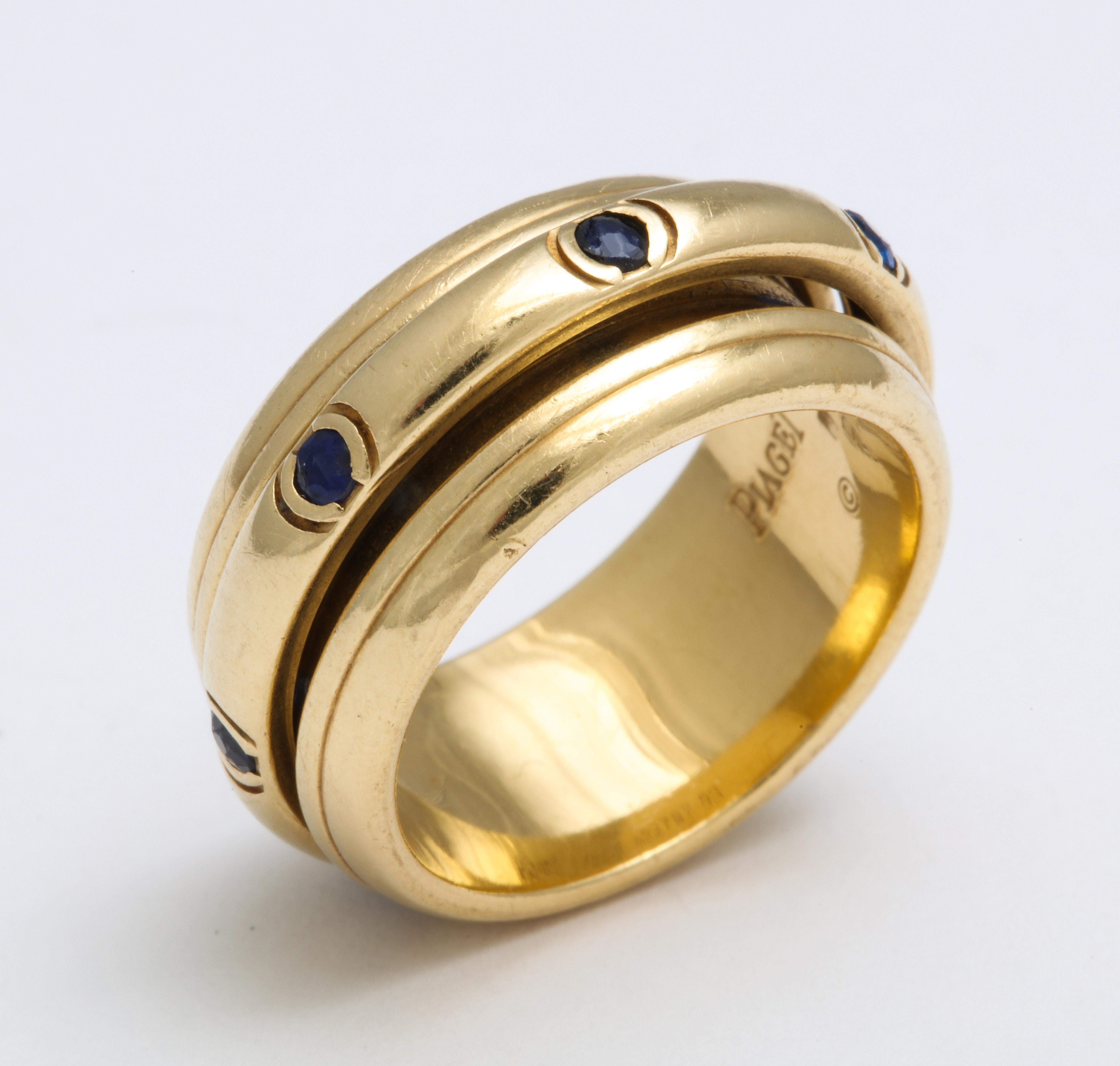 An amusing, calming ring of 18 Kt gold with sapphires in the center band. The center rotates as you spin it giving it the name of a fidget ring. Everybody fidgets sometimes. Here you have a ring to make fidgeting easy and more fun than shaking your