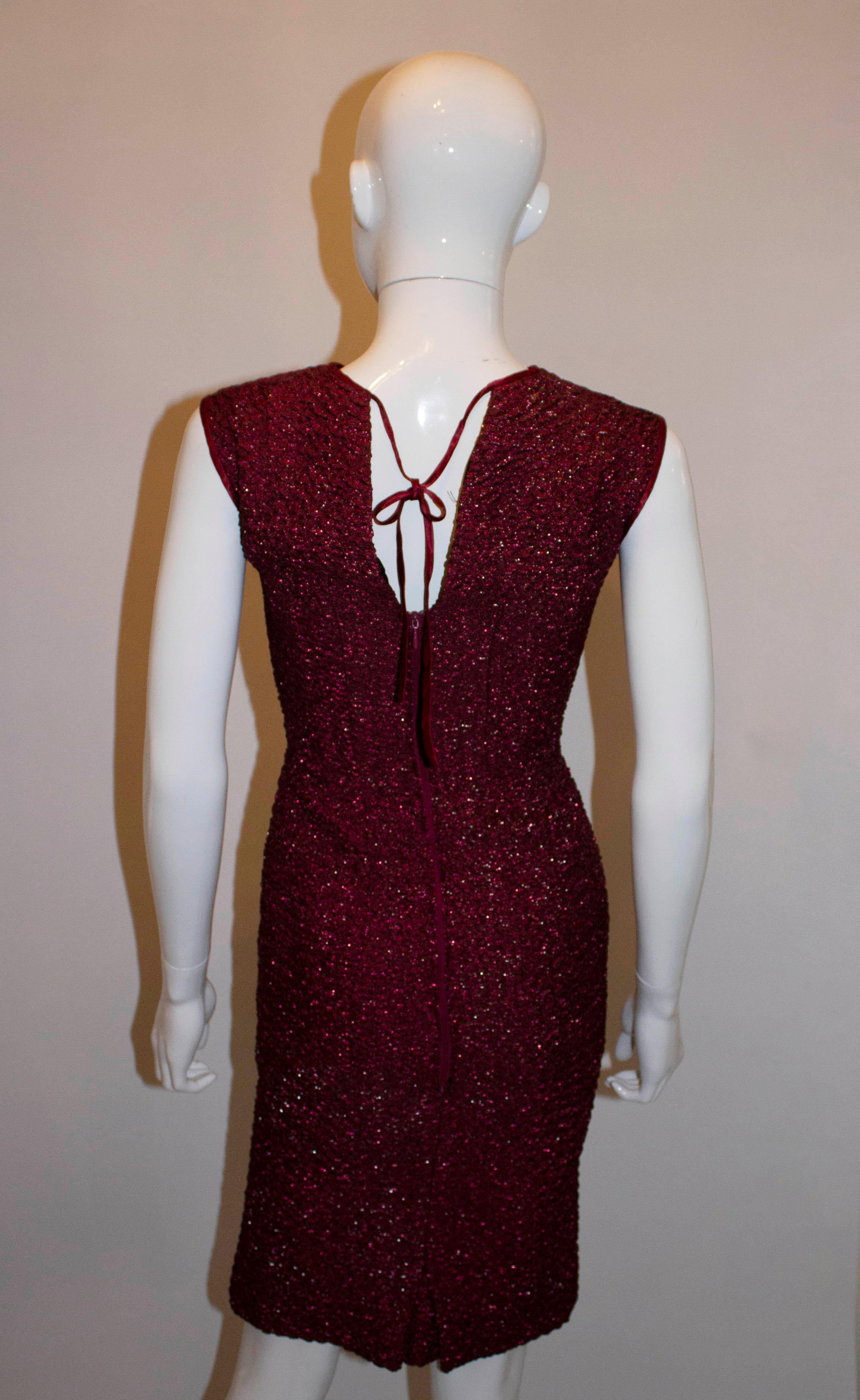 A chic vintage cocktail dress by Pichat  Chaleard (  Paris and Lyon) . The dress is a pretty raspberry colour with sparkle effect. It is fully lined, with a v back line and ribbon tie at the neck.
Measurements: Bust 35'', waist 25'',length 39''