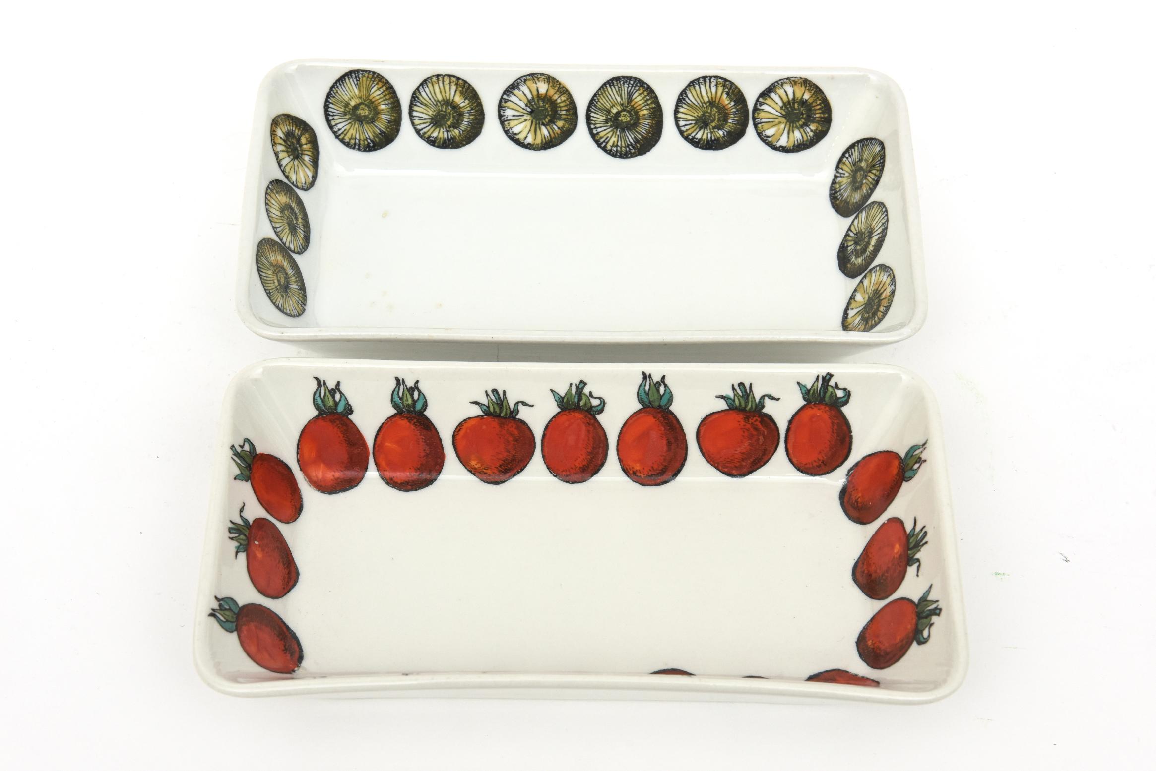 This pair of fabulous and hard to find vintage 1960's hallmarked Piero Fornasetti porcelain rectangular serving bowls, appetizer dishes have hand painted vegetables or fruits surrounding the inner perimeter. These are obscure, rare and most unusual.