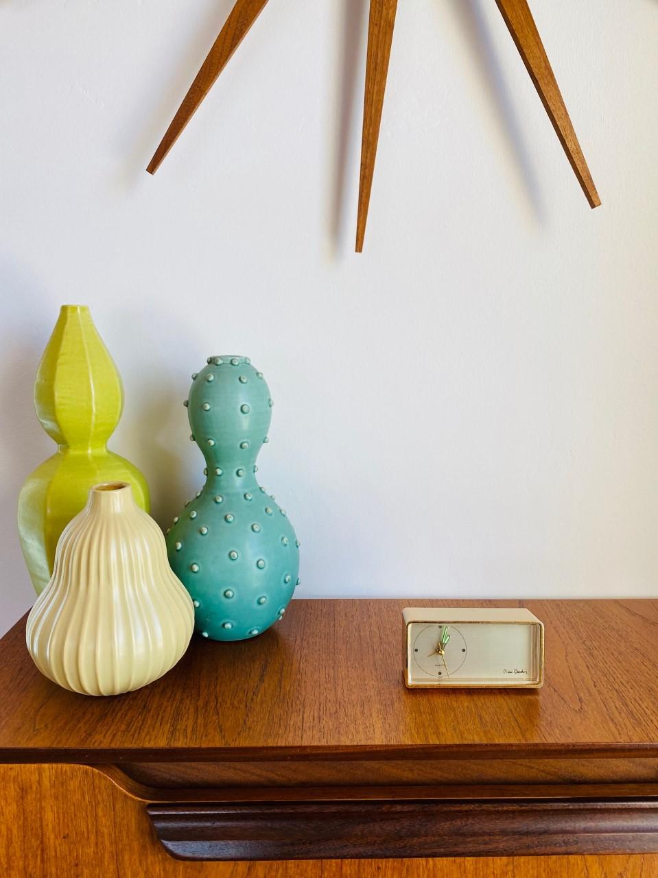 Incredible and attractive vintage Pierre Cardin alarm clock. This piece in working condition is minimal and modern reflecting the visionary designer's principles of design. Covered in brass, this timepiece follows minimalist lines and signed by the