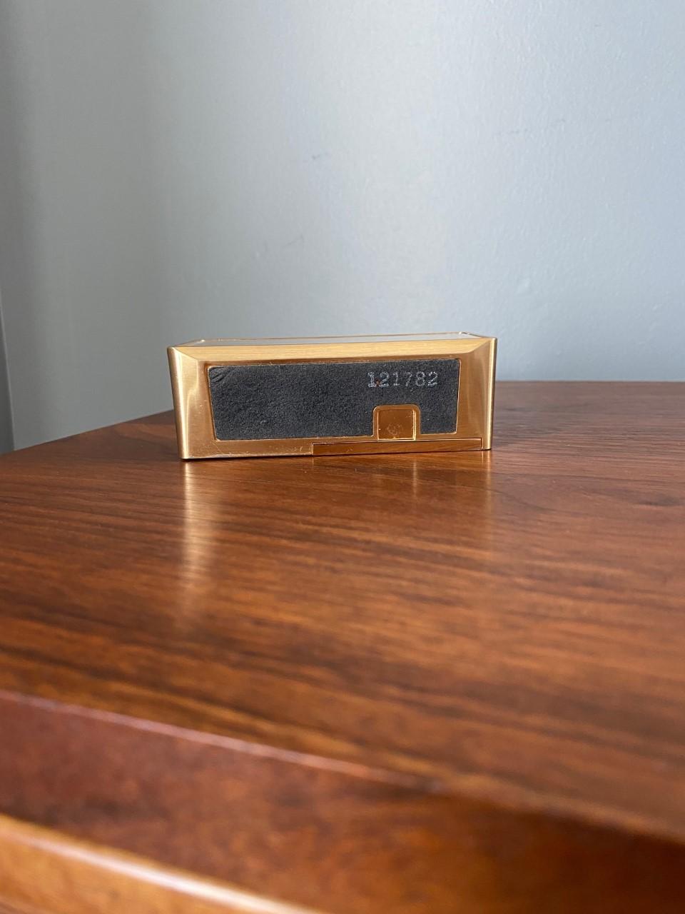 Incredible and attractive vintage Pierre Cardin alarm clock. This piece in working condition is minimal and modern reflecting the visionary designer's principles of design. Covered in brass, this timepiece follows minimalist lines and signed by the