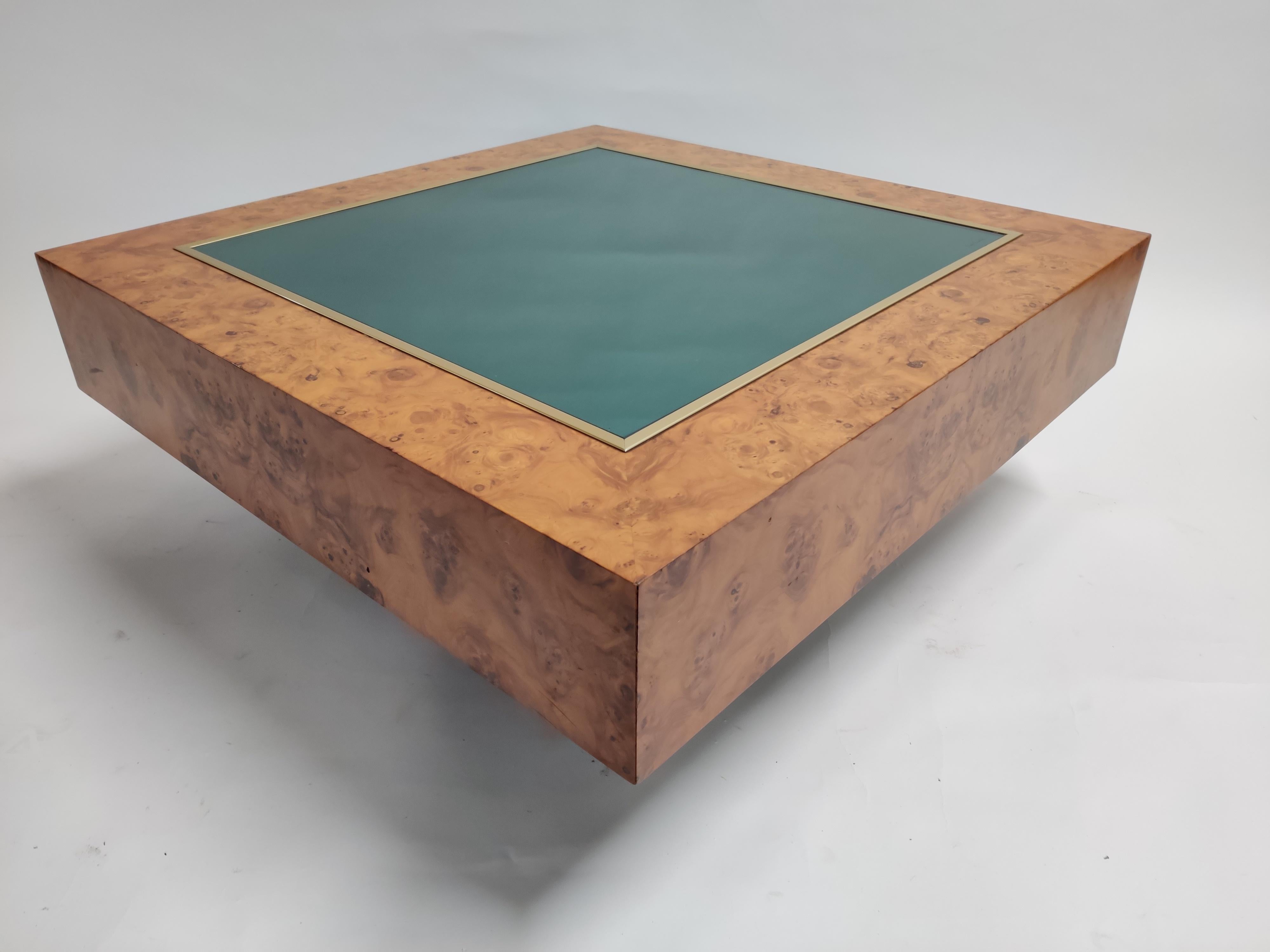 A very rare coffee table designed by Pierre Cardin.

As you can see in the pictures, the table is signed at the glass. 

The coffee table is made out of a mixture of materials: brass, glass and burl wood. 

The burl wood gives this table a