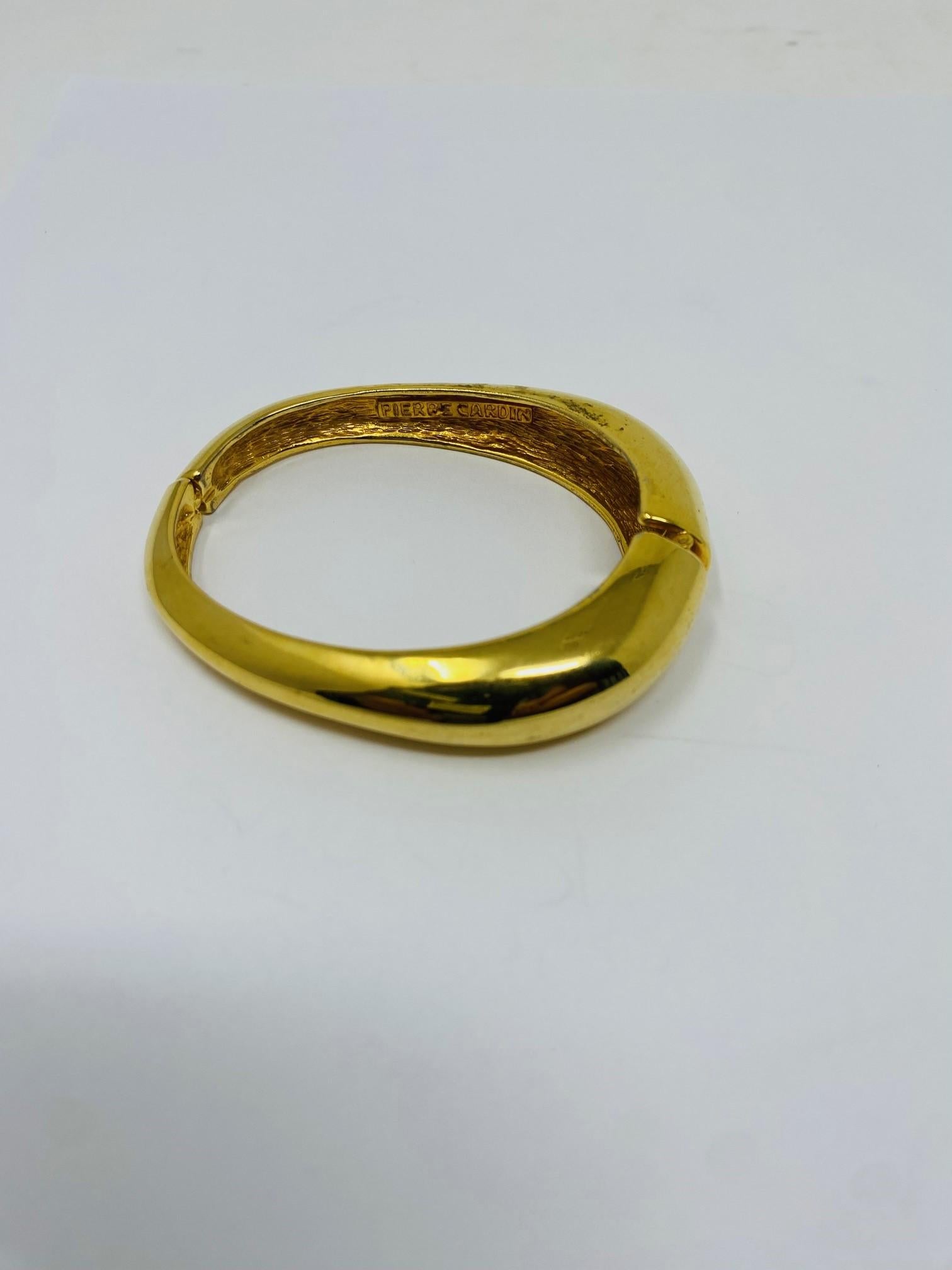 Wonderful abstract bracelet cuff. All in golden brass metal by Pierre Cardin haute couture - iconic and sculptural, this cuff is from the height of Cardin's creative output, 'Futuristic' and modernist in its style. This piece with a clasp like