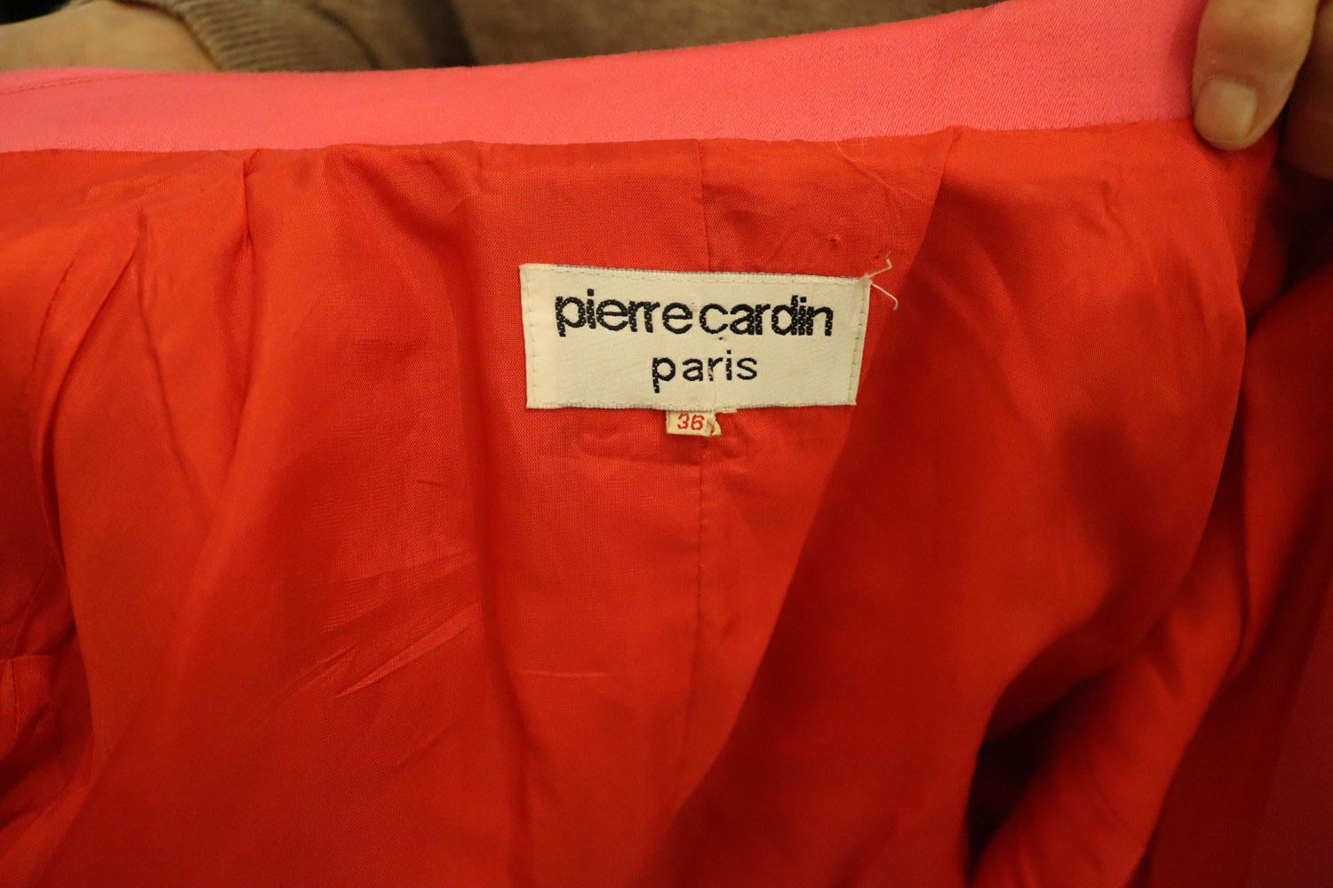 A headturning vintage jacket by Pierre Cardin. 
The jacket has wonderful tailoring , with attractive stitch detail on the collar ,  attractive buttons, and a wonderful colour clash red lining. The jacket has a two button detail at the back and