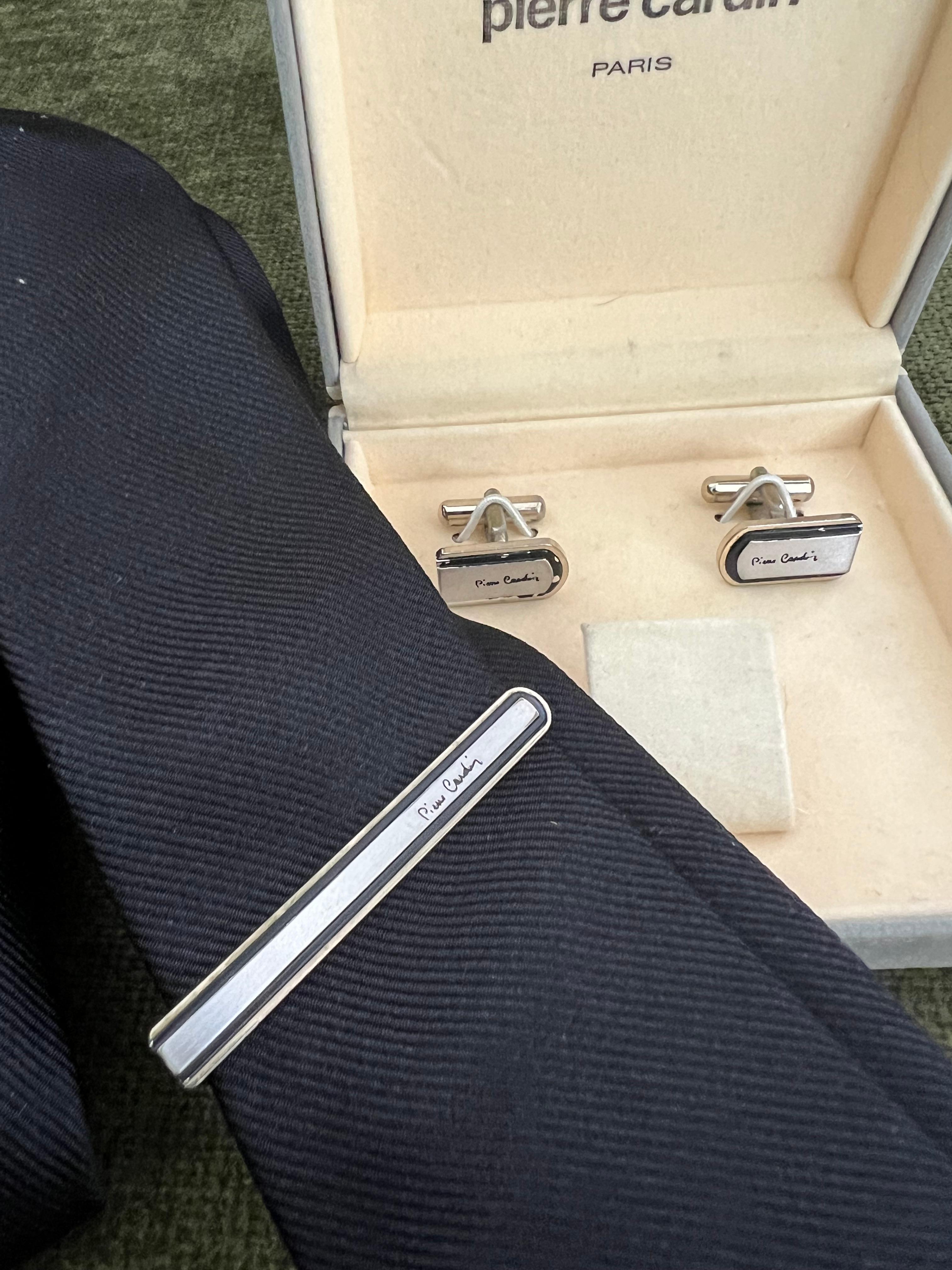 Vintage PIERRE CARDIN Steel Cufflinks & Tie Clip With Original  Case Circa 1970

A pair of Pierre Cardin cufflinks, with the iconic Pierre Cardin logo, with swivel back fittings. These vintage, steel cufflinks come in their original Pierre Cardin