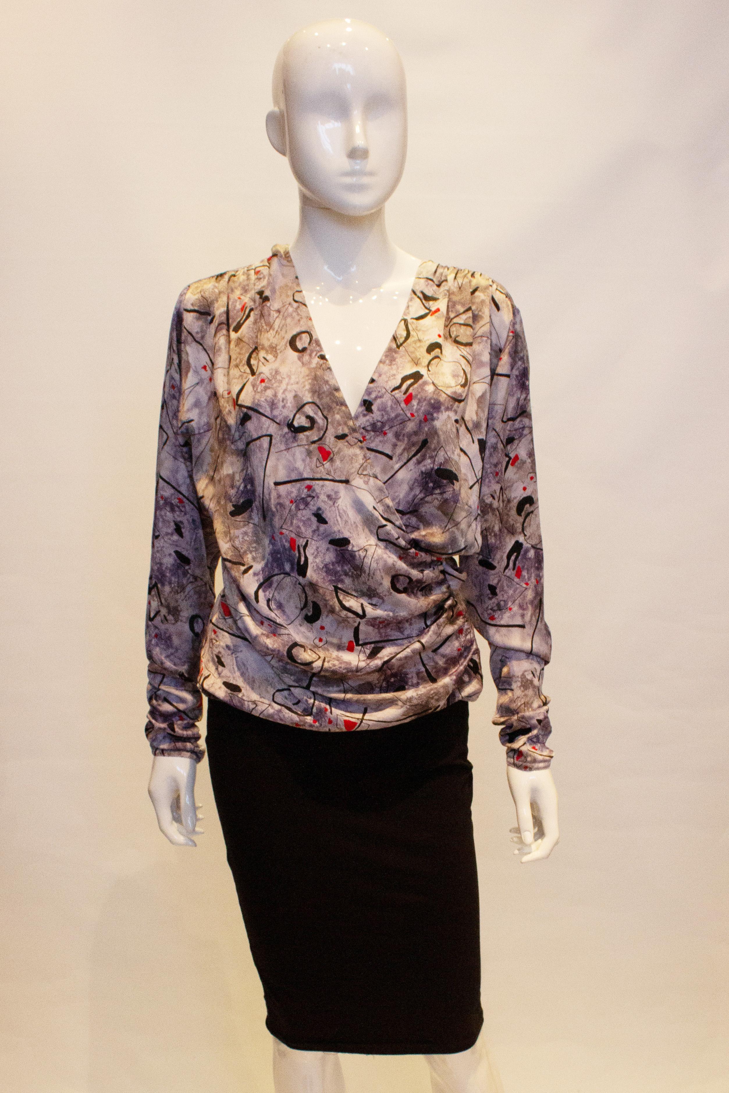 A pretty vintage top by Pierre Cardin. The wrap over top has gathering on the shoulders, a wrapover front , side zip opening and tapered sleaves. 
Measurements : Bust up to 42', length 26''