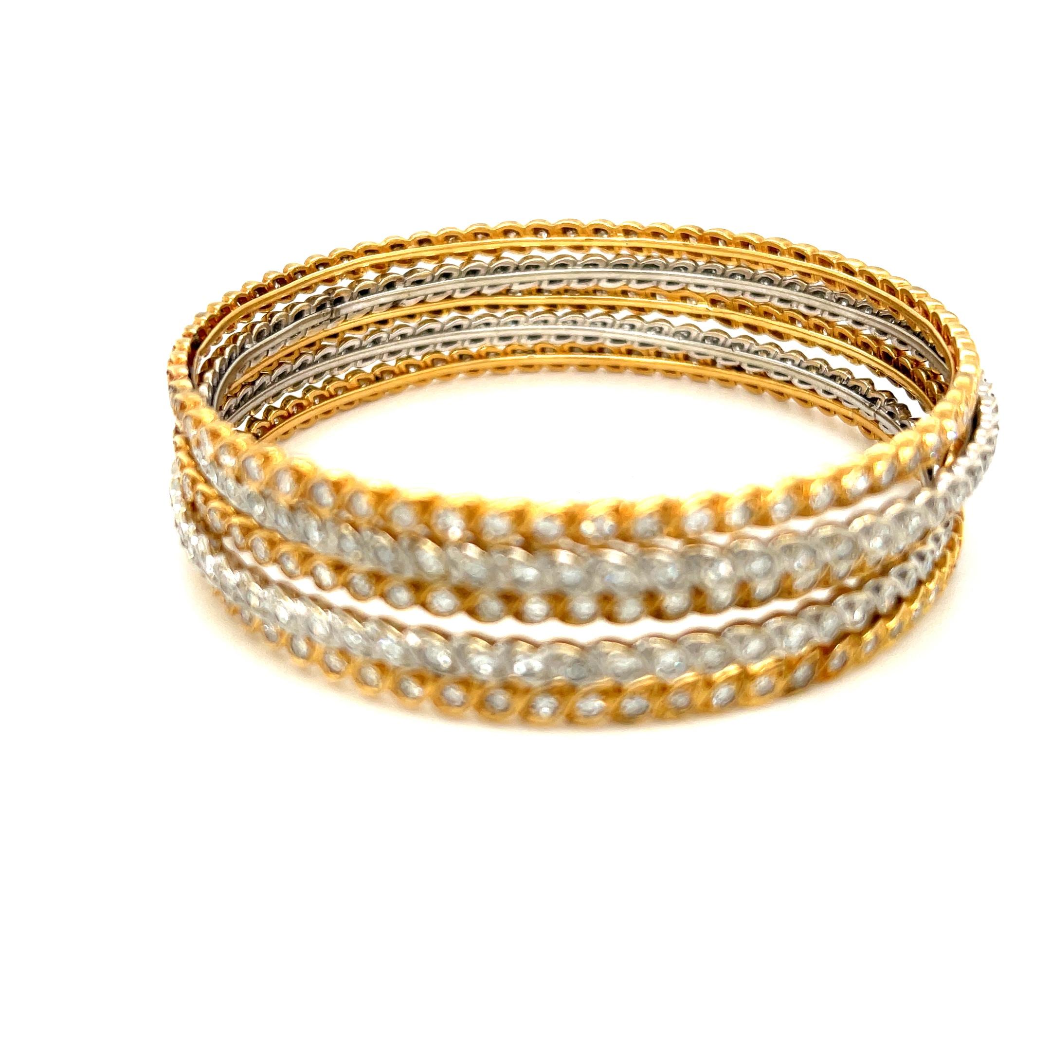 Rare bangle vintage en or blanc et jaune 18k serti de diamants par le fabricant français Sterlé, vers 1960. Cet ensemble de 5 bracelets présente un intéressant décor cachemire. Les bracelets contiennent environ 335 diamants d'un poids total