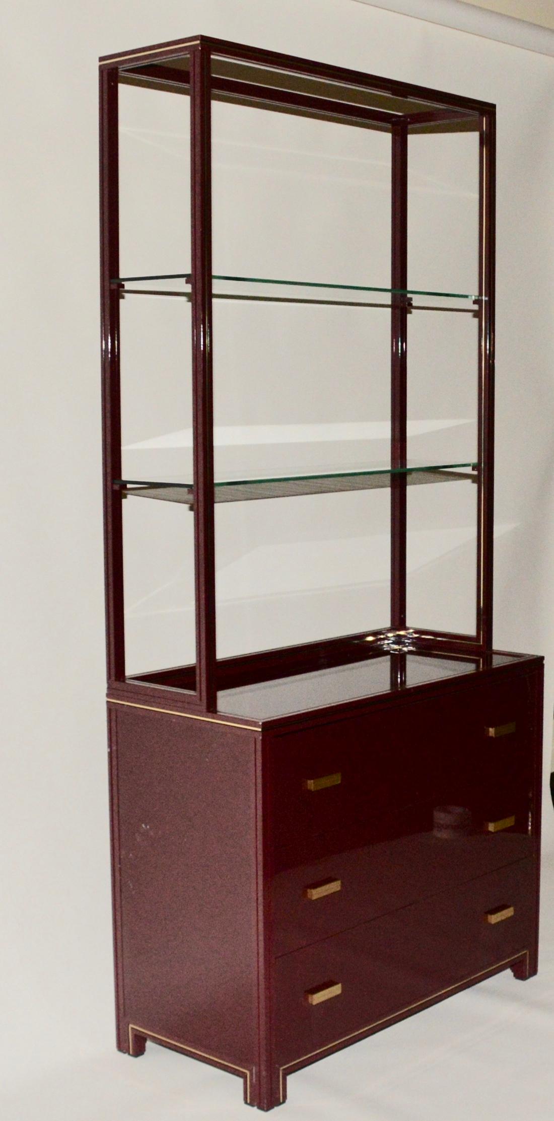 Vintage Pierre Vandel cabinet with three draws and two glass shelves on top in a burgundy gloss finish. A fabulous item by the iconic French designer Pierre Vandel whose designs are well documented in design literature and are still in high demand
