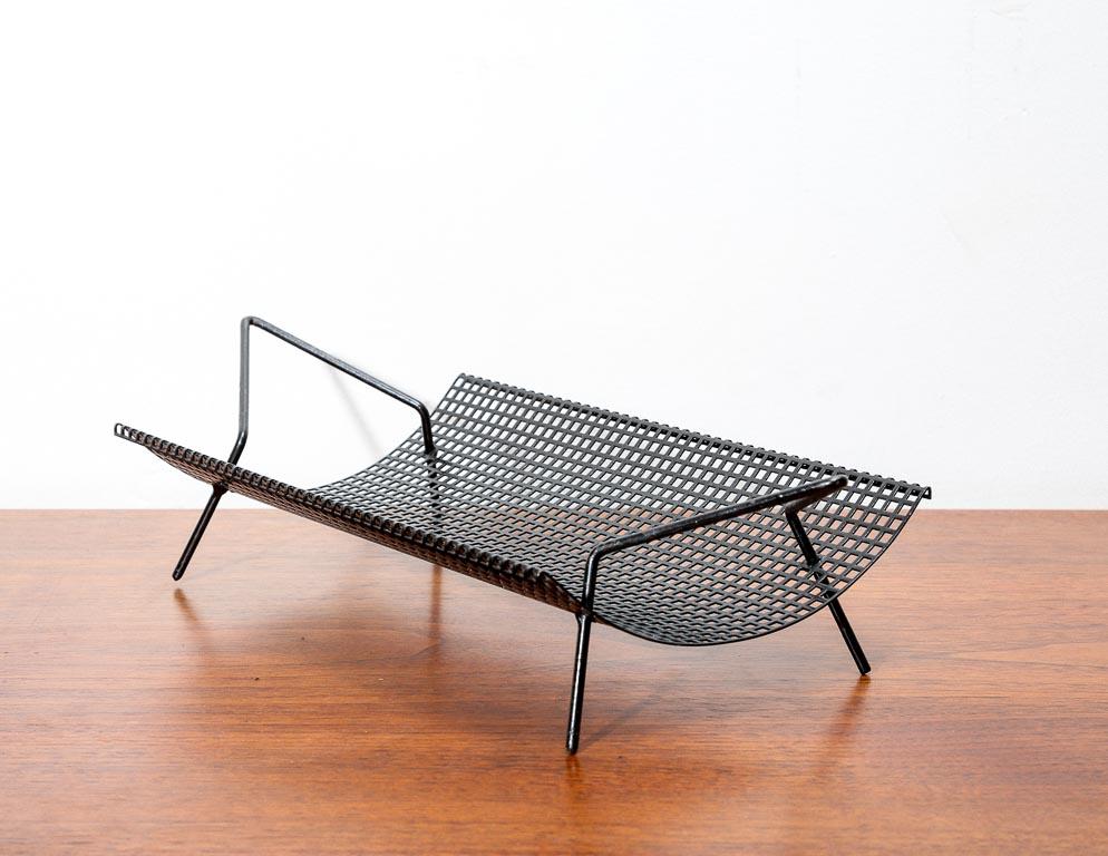 Vintage fruit bowl or catch-all by Pilastro, Holland. Scooped black perforated steel bowl with skinny steel rod feet.