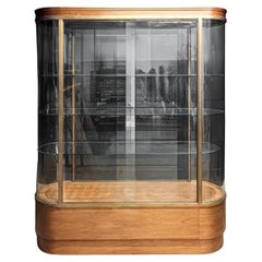 Antique pill shaped bow ended display cabinet