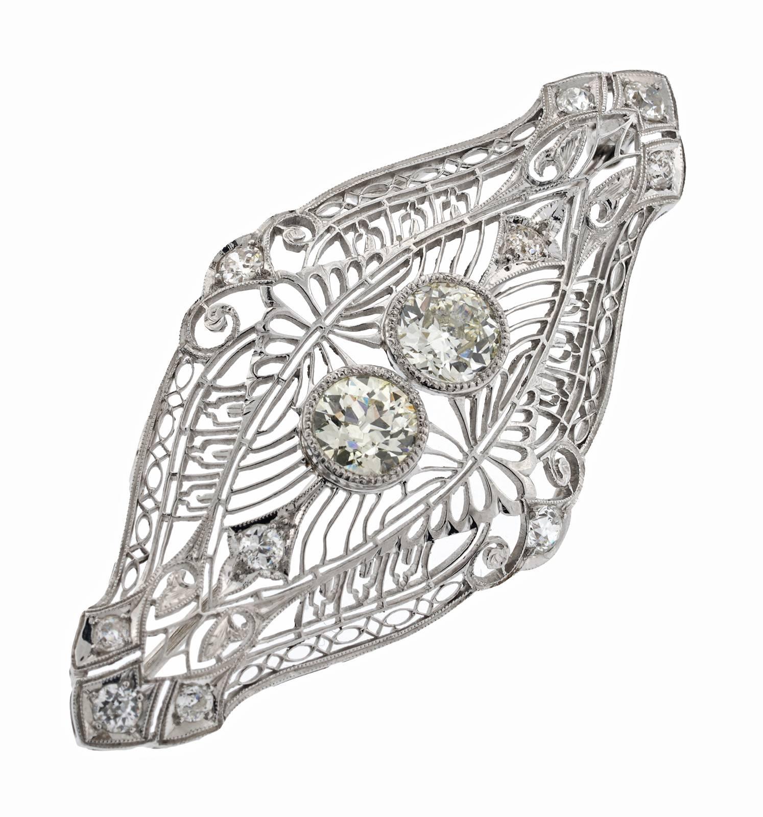 Antique Platinum Pin, convertible to pendant with rings on reverse.  Contains 2 European cut diamonds for a total 2.20ct, they are K/L color VS2 Clarity.  It also contains 10 European cut diamonds totaling 1.20cts, which range from H-J Color and