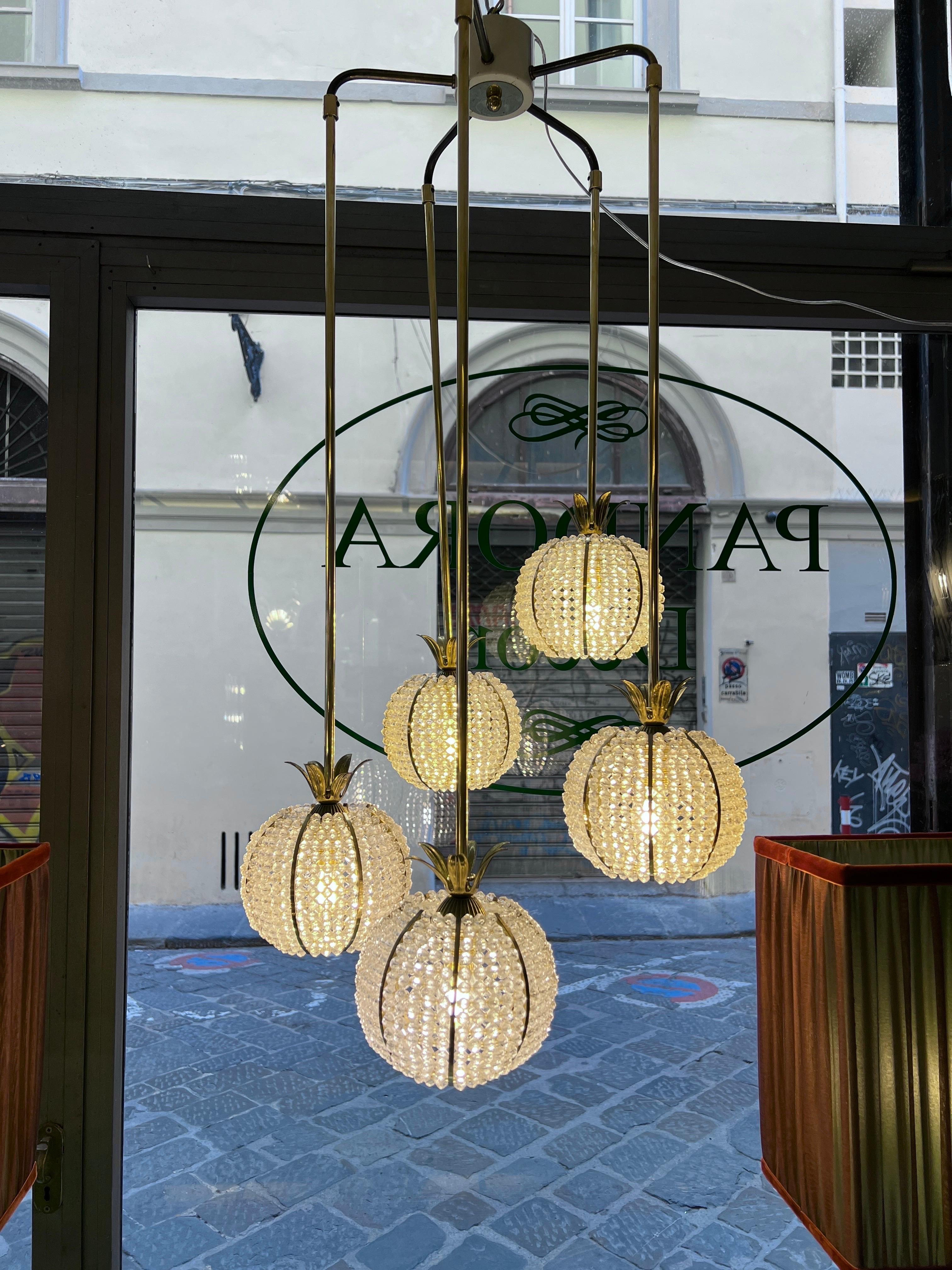 Vintage cascade chandelier made by Emil Stejnar for Rupert Nikoll, manufacted in Austria in the 60s. It is made of 5 brass pineapples with hundreds of acrylic beads. Trendy lamp in Hollywood Regency style.
Each balls consist of many acrylic beads,