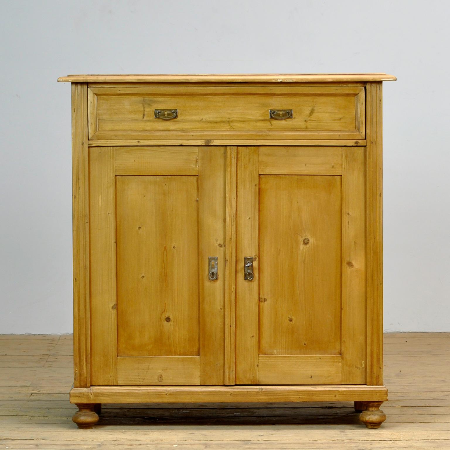 Dresser made of pine. Produced in the 1930s. With a drawer and a shelf inside.