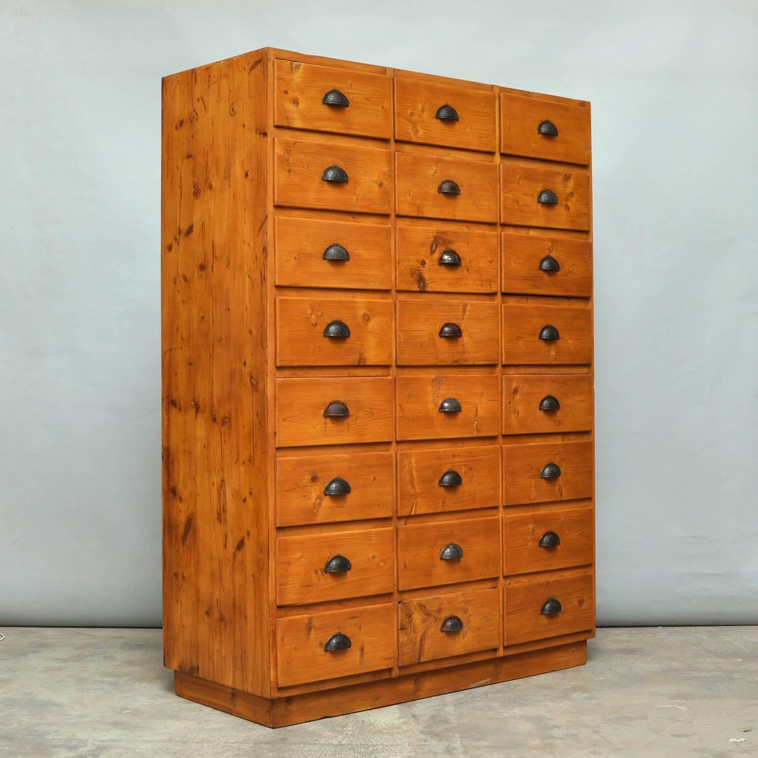 This vintage chest of drawers originates from Germany. It is made from pine and features 24 drawers. The drawers open and shut smoothly.