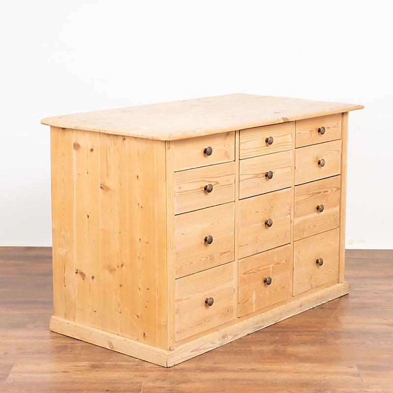 Fun and function combine in this pine chest of 12 drawers. This delightful pine apothecary originally served as a shop counter or storage cabinet. Counters similar to this were used throughout shops in the European countryside and are a great find